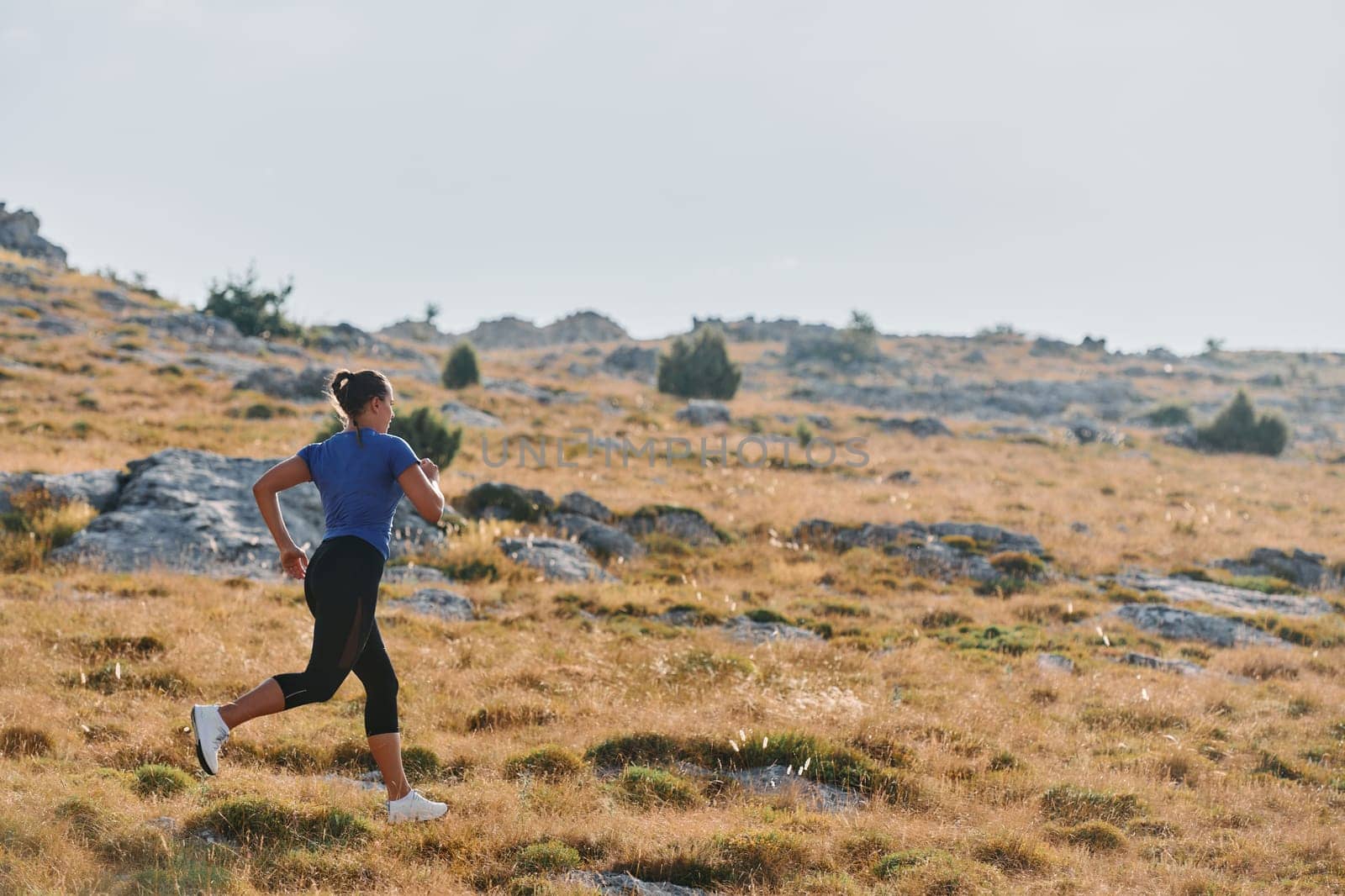 Empowered Runner Embracing Nature's Beauty on a Serene Morning Trail. by dotshock