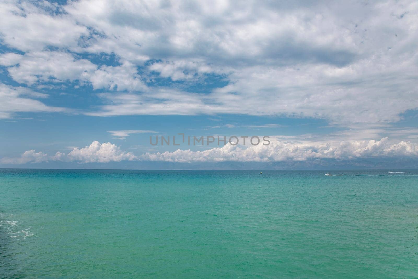 Beauty cloud against a blue sky background. Sky slouds. Blue sky with cloudy weather, nature cloud over the sea. Over the sea white clouds, blue sky and sun. by Costin