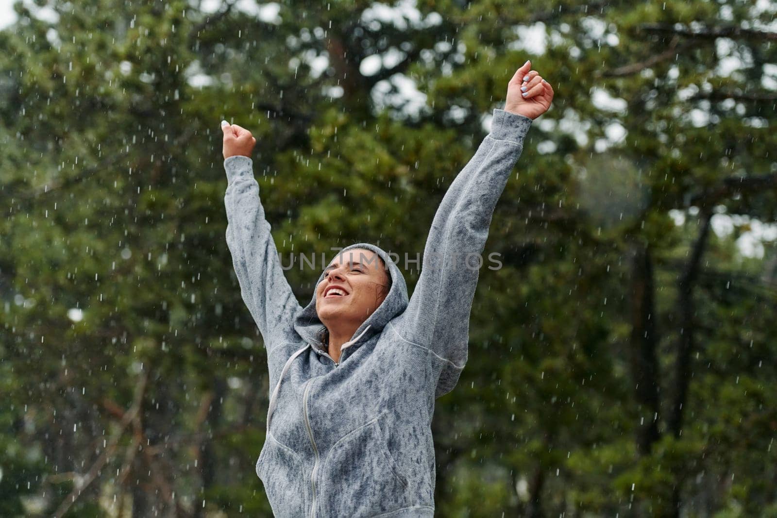 A stunning woman savors the tranquility of a rainy day after a rigorous run, finding solace and rejuvenation in the soothing rhythm of the falling rain.