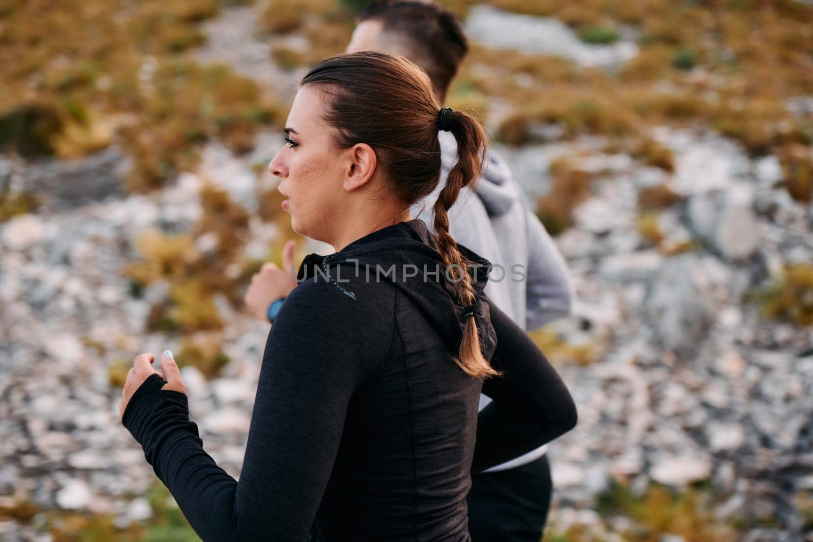 Couple conquer challenging mountain trails during an invigorating morning run.