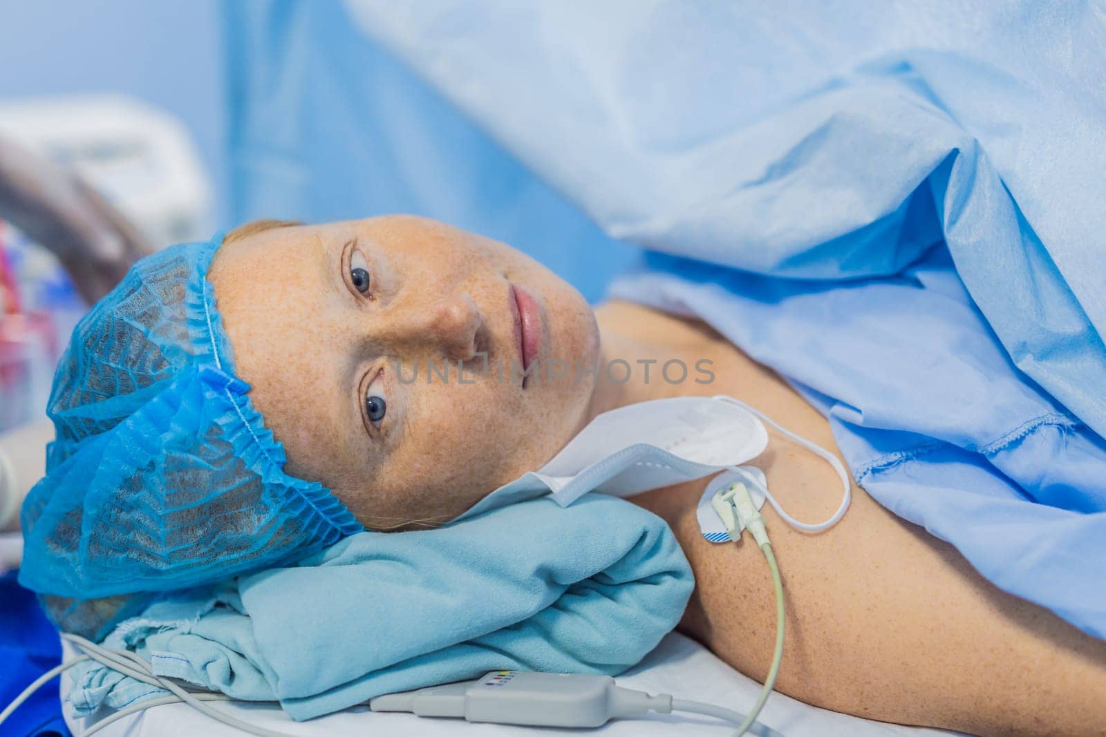 A woman lies in the operating room, ready for surgery. Surrounded by advanced medical equipment and healthcare professionals, she exhibits calmness and trust, highlighting the importance of the procedure by galitskaya