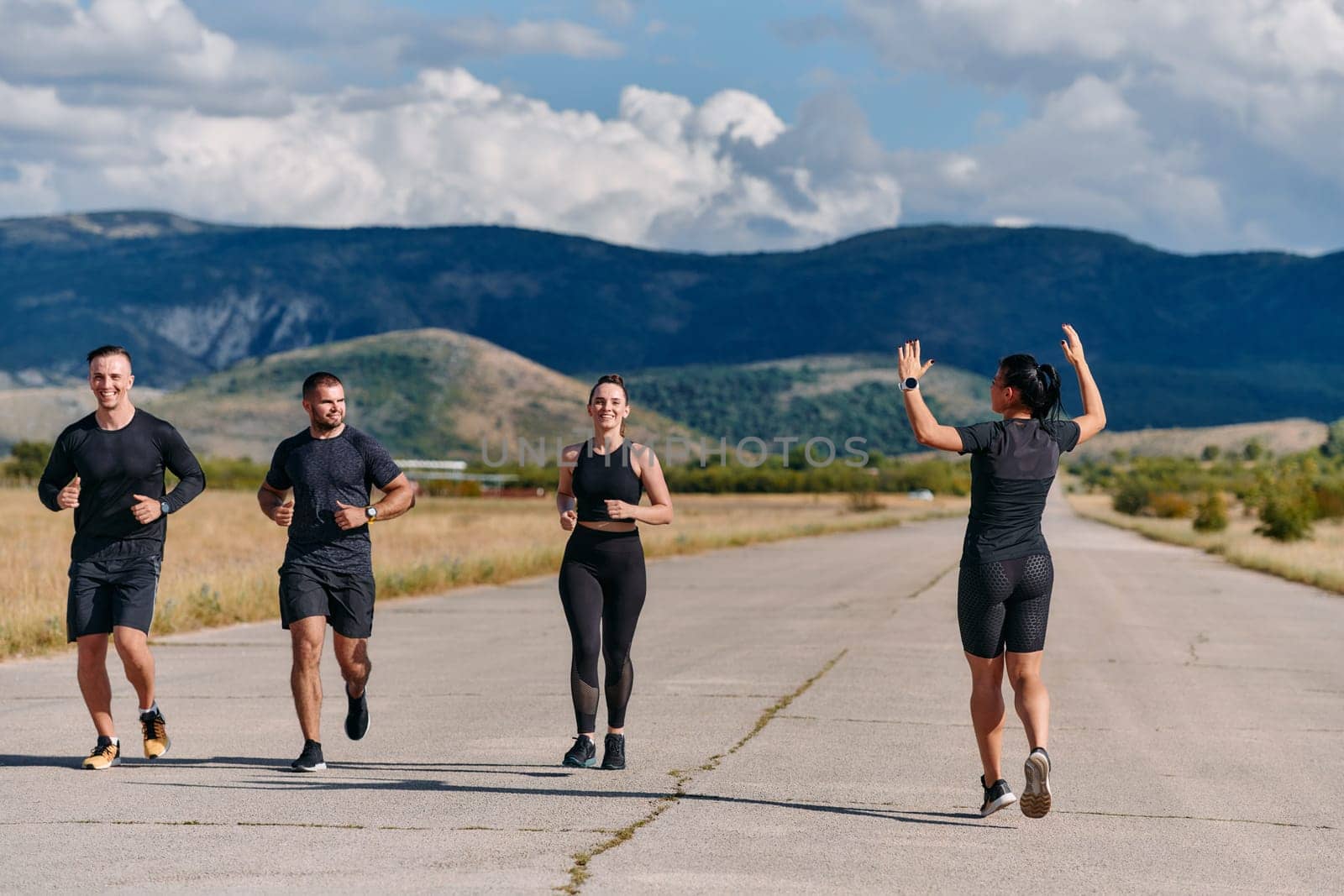 A professional athletic team as they train rigorously, running towards peak performance in preparation for an upcoming marathon.