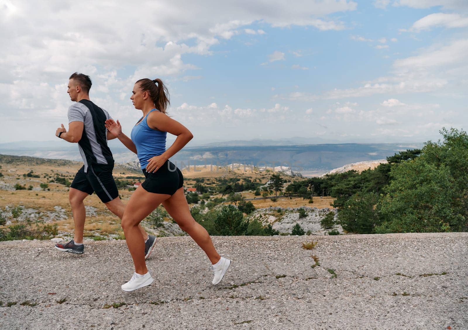 Couple conquer challenging mountain trails during an invigorating morning run.