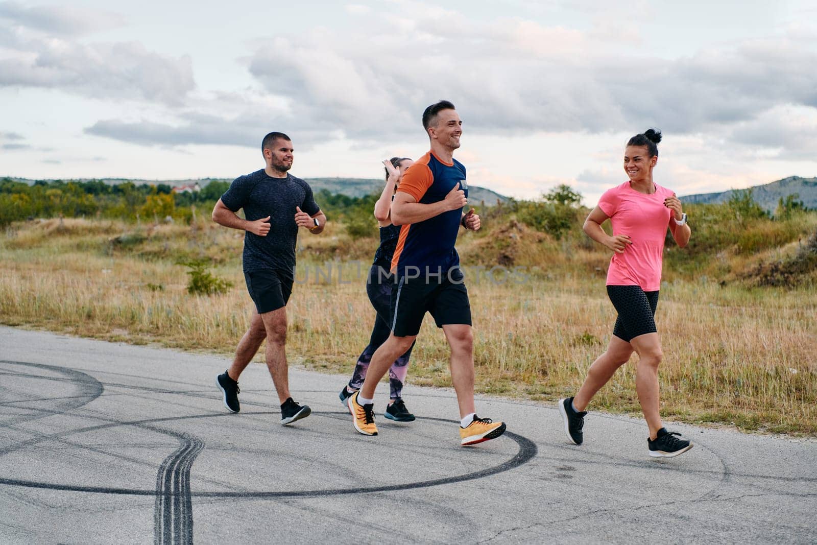 A professional athletic team as they train rigorously, running towards peak performance in preparation for an upcoming marathon.