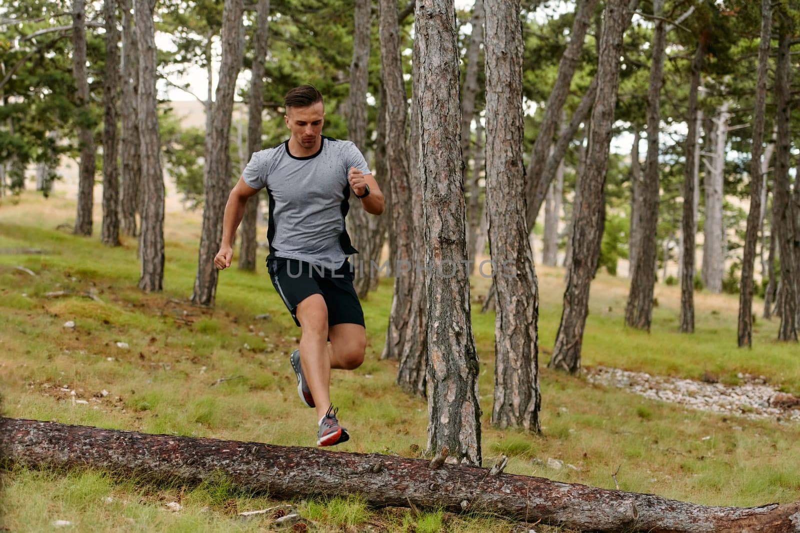 Determined Man Conquering Forest Obstacles with Grit and Speed by dotshock