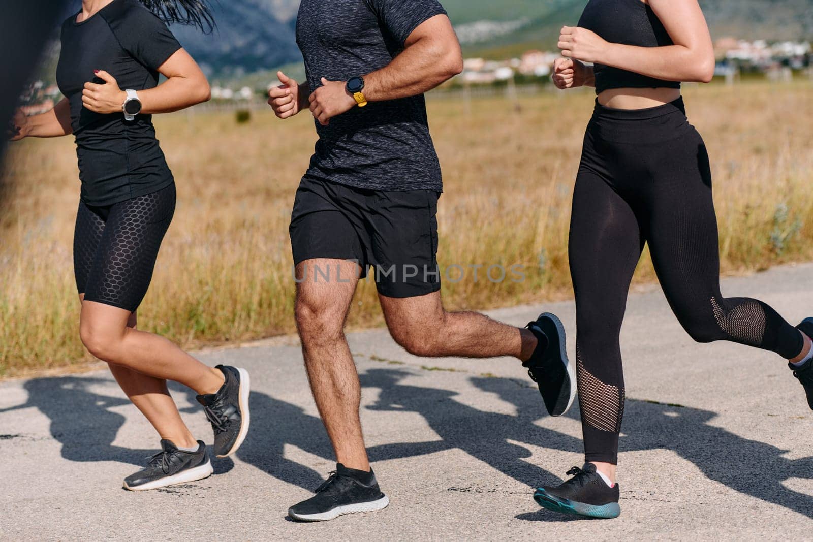 A professional athletic team as they train rigorously, running towards peak performance in preparation for an upcoming marathon.