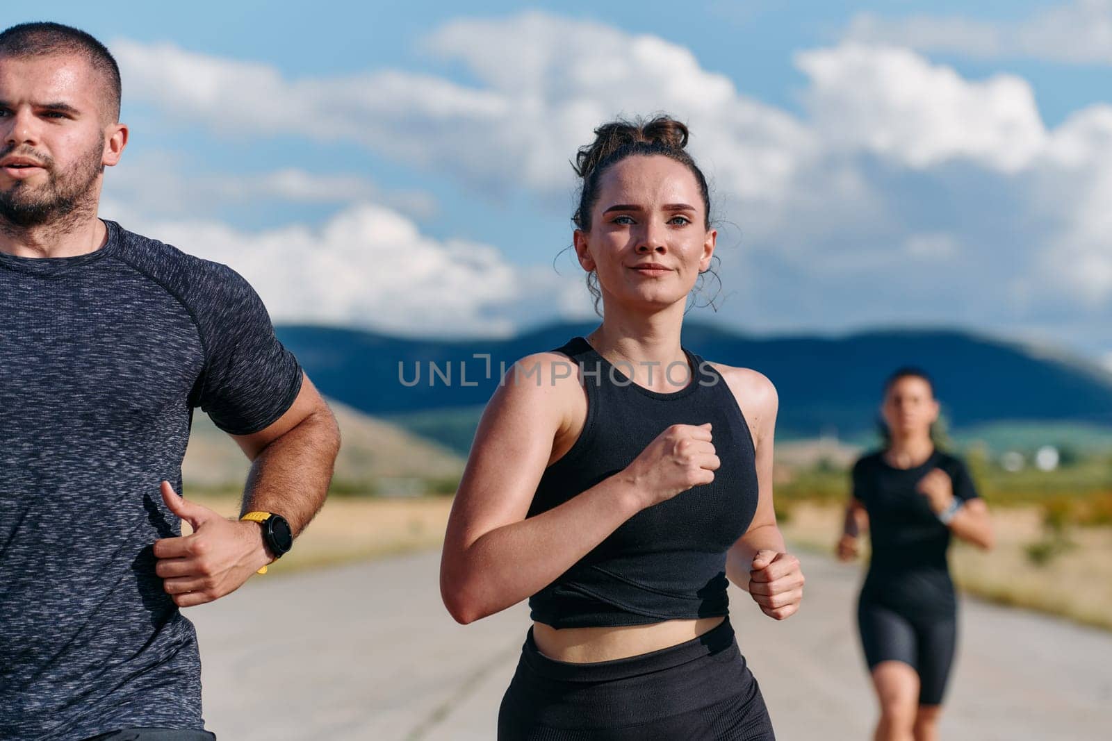 A professional athletic team as they train rigorously, running towards peak performance in preparation for an upcoming marathon.