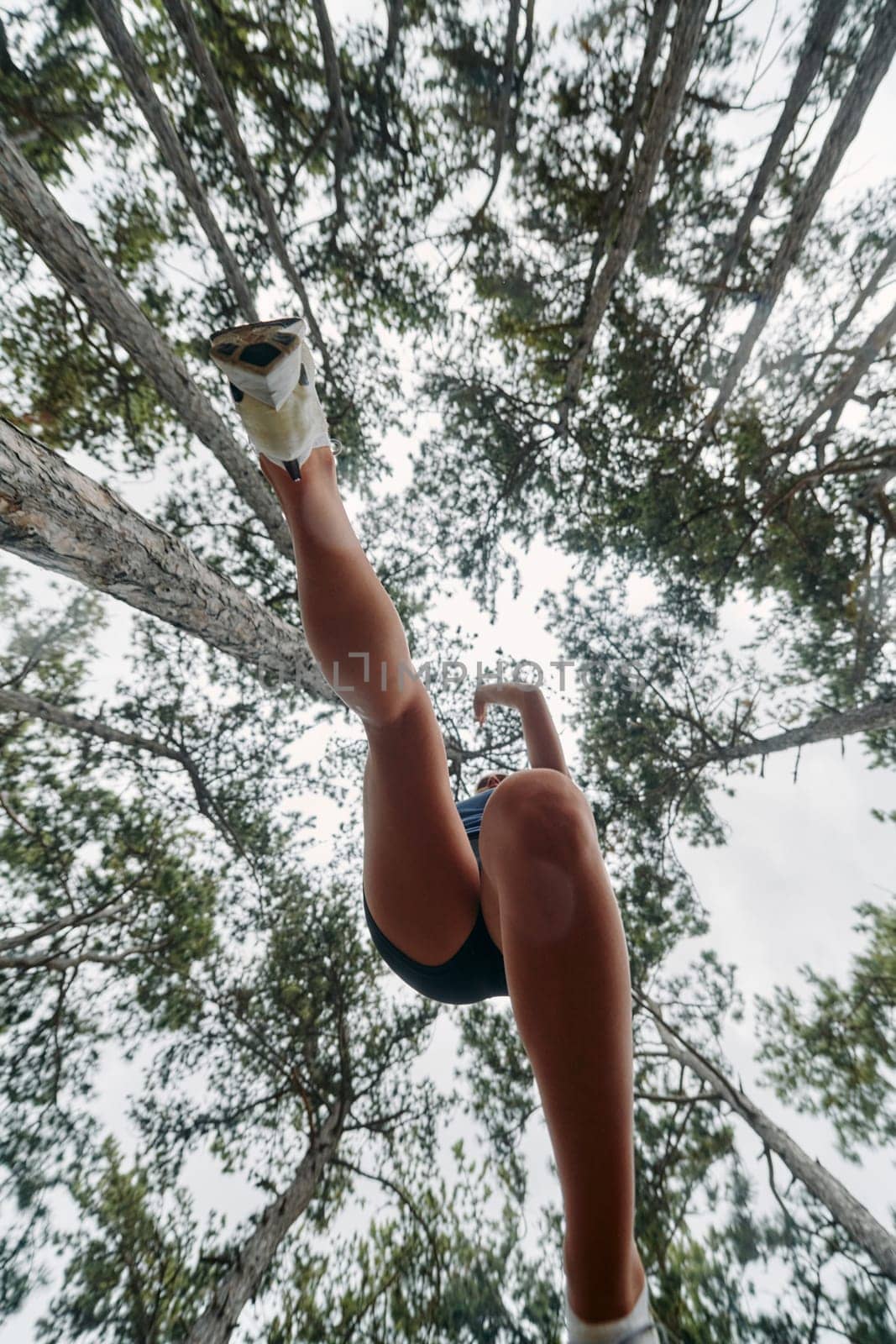 Adventurous Woman Overcoming Forest Obstacles with Determination and Agility. by dotshock