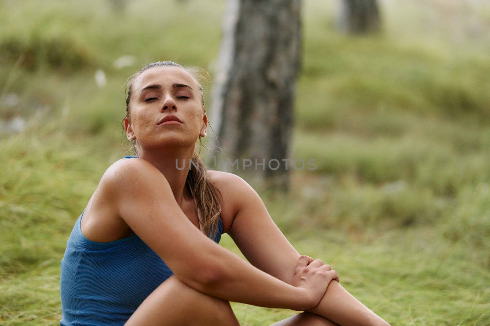A woman takes a moment to rest and recuperate after an intense run, finding solace and rejuvenation in the tranquility of her surroundings.
