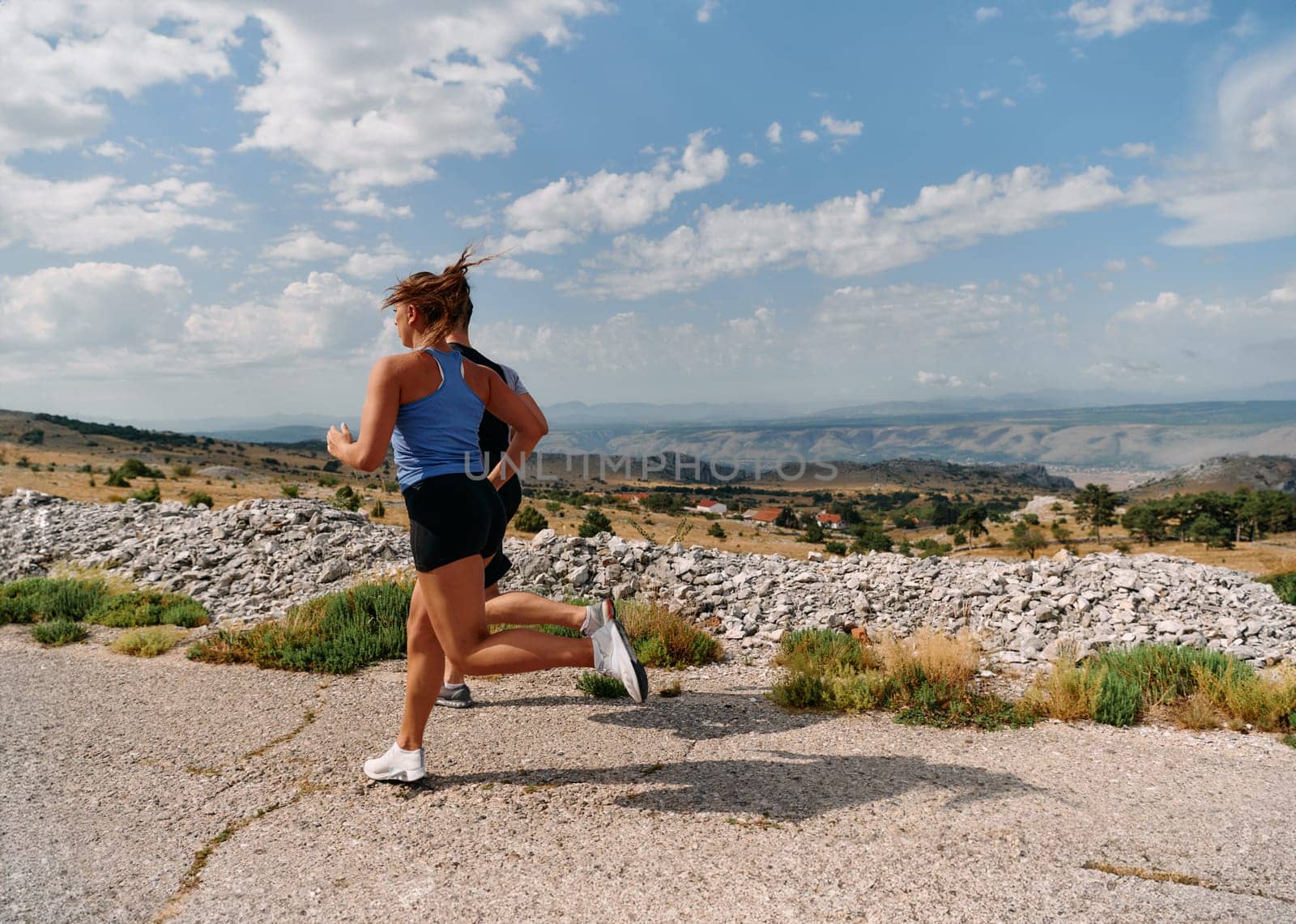 Couple conquer challenging mountain trails during an invigorating morning run.