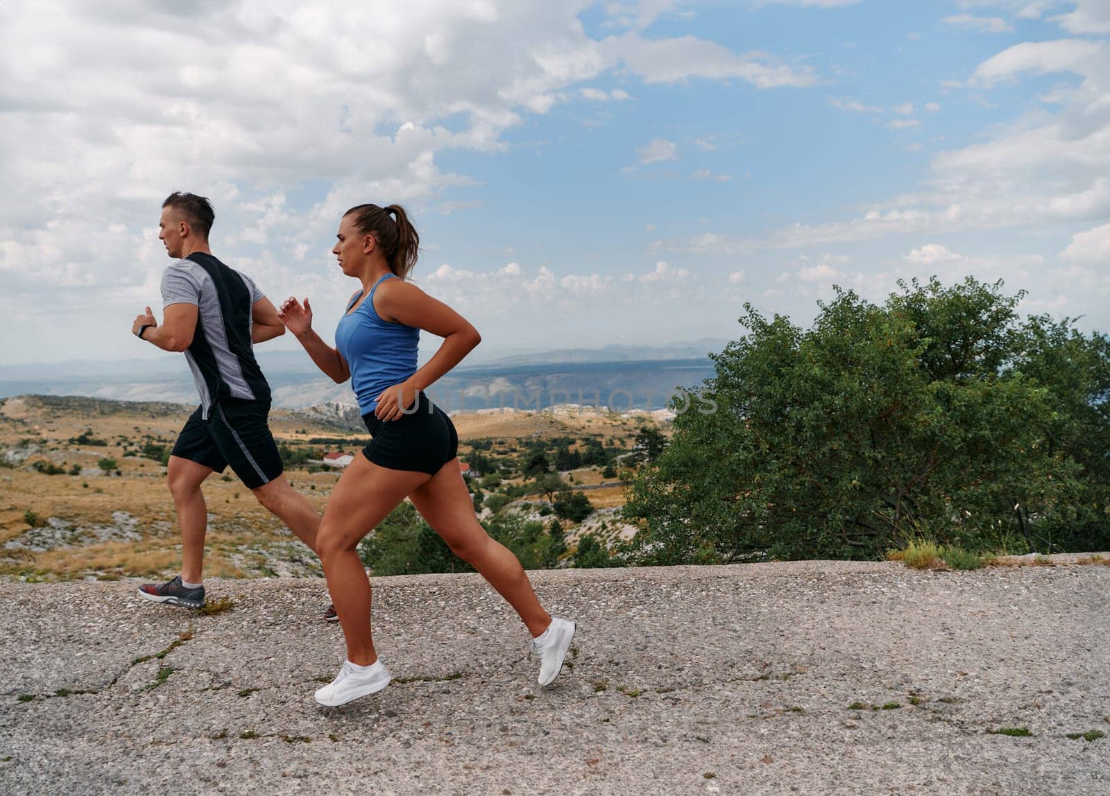 Couple conquer challenging mountain trails during an invigorating morning run.