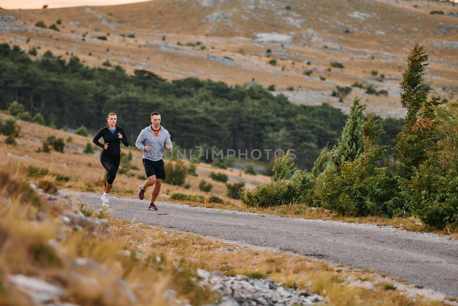 Couple conquer challenging mountain trails during an invigorating morning run.