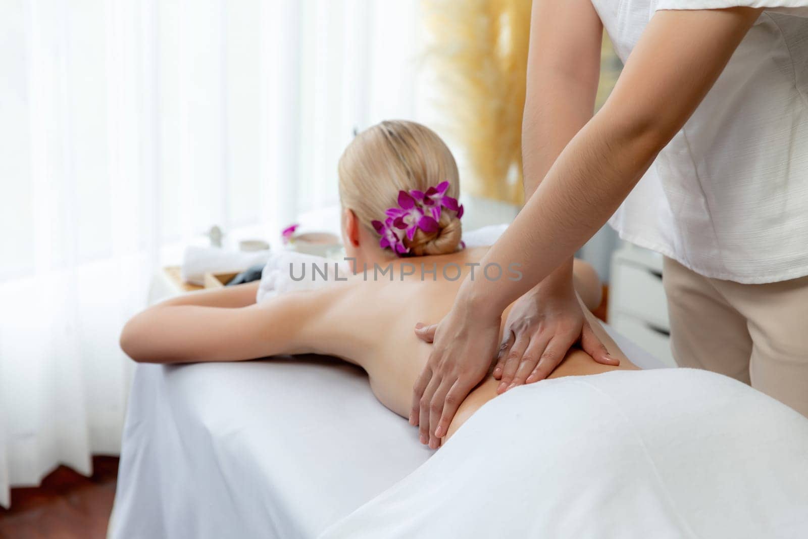 Caucasian woman customer enjoying relaxing anti-stress massage. Quiescent by biancoblue