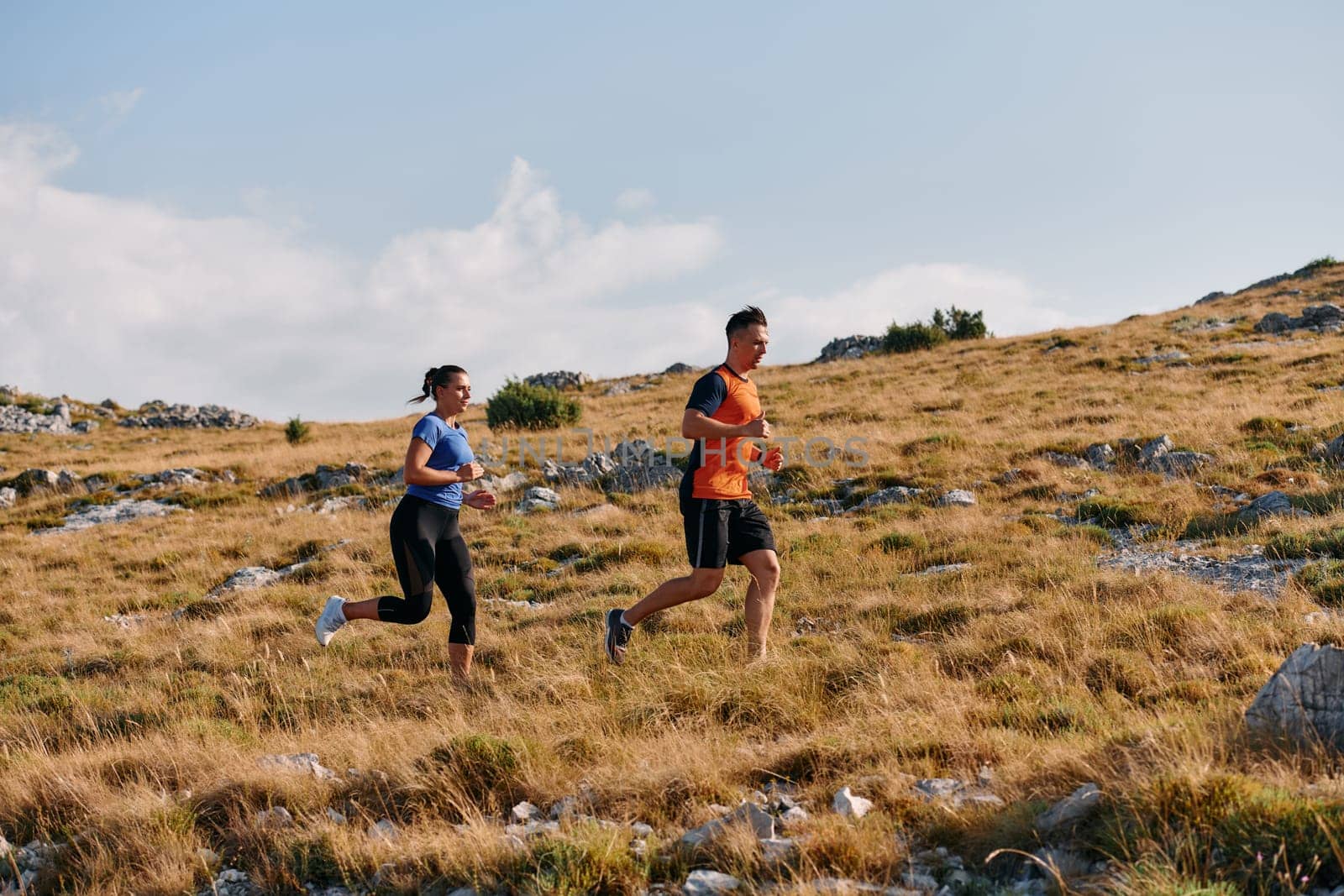 Couple conquer challenging mountain trails during an invigorating morning run.