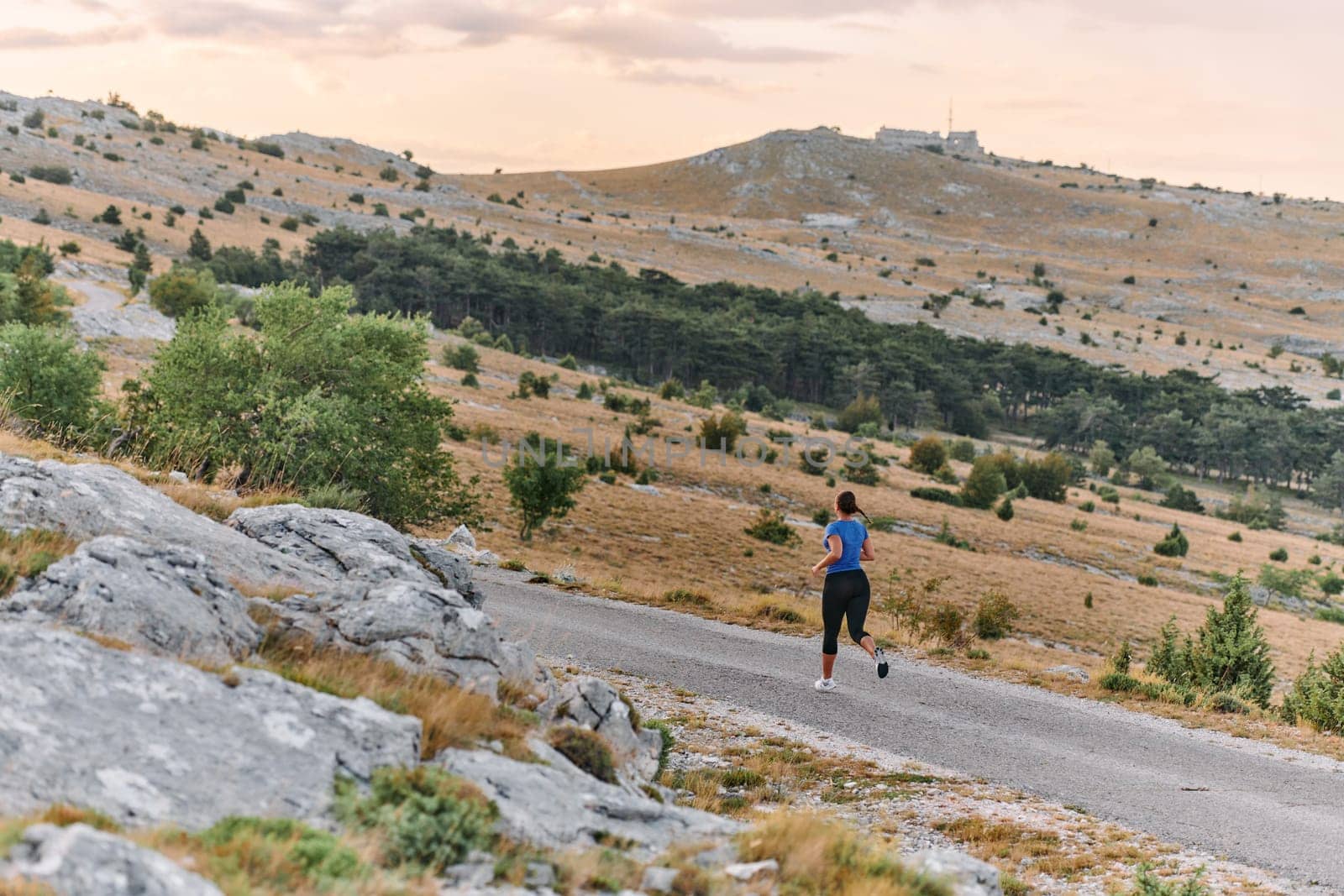 Empowered Runner Embracing Nature's Beauty on a Serene Morning Trail. by dotshock