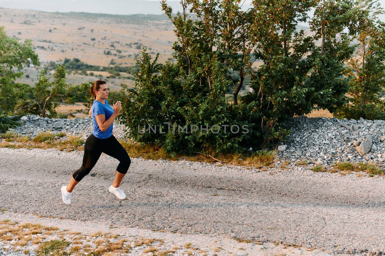 Empowered Runner Embracing Nature's Beauty on a Serene Morning Trail. by dotshock