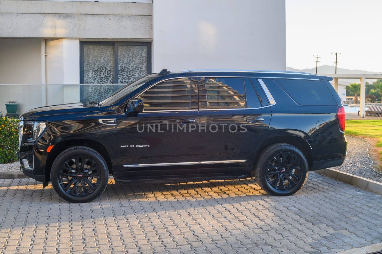 Gaziveren Cyprus 05.27.2024 - black GMC Yukon in the parking lot outside the house 1