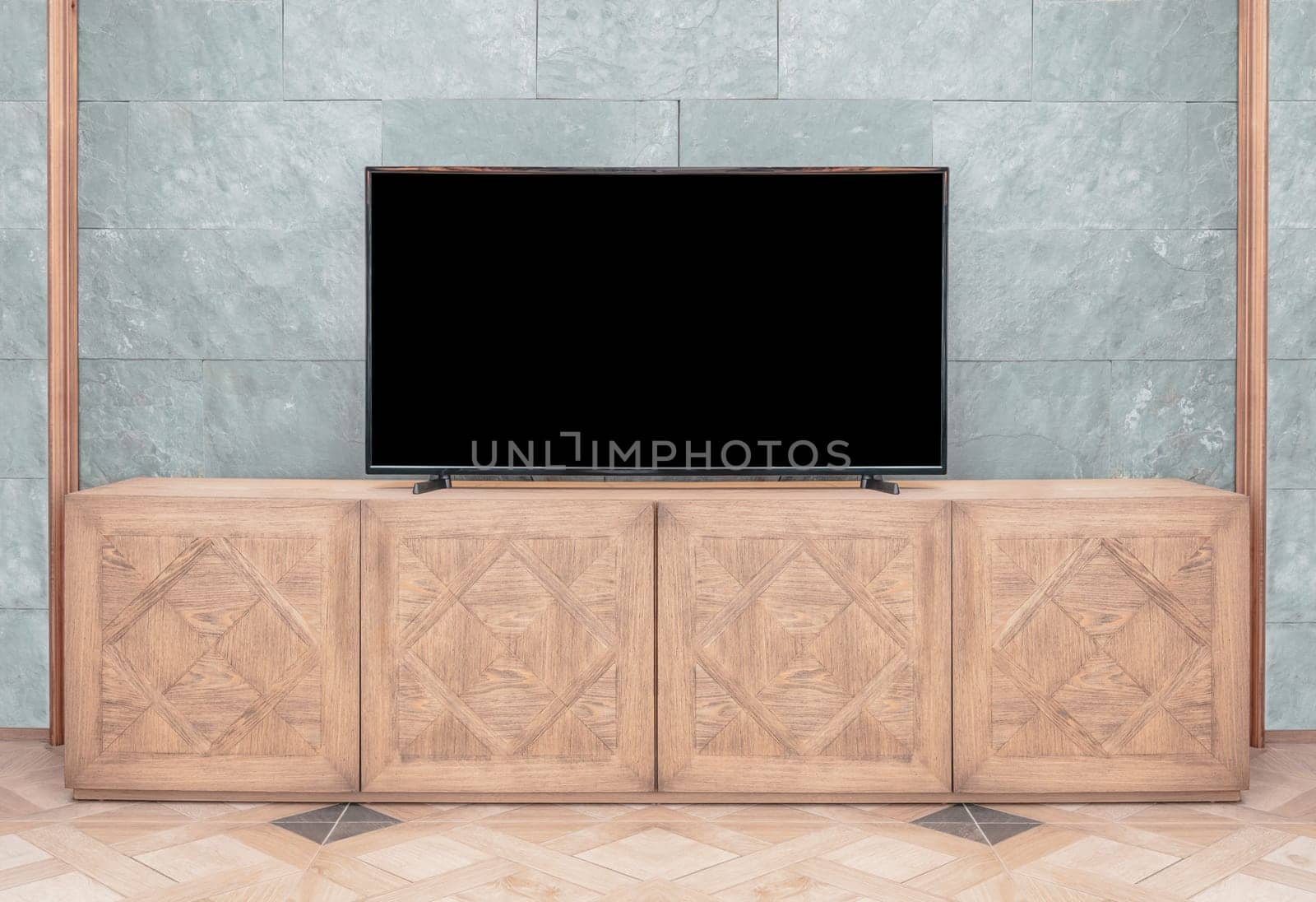 LCD led tv with blank black screen standing on wooden television cabinet