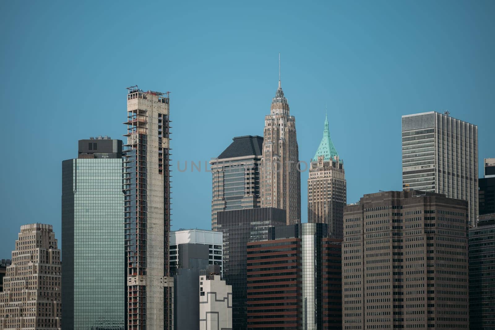 View of the stunning New York City skyline featuring diverse skyscrapers and modern high-rise buildings against a clear blue sky.