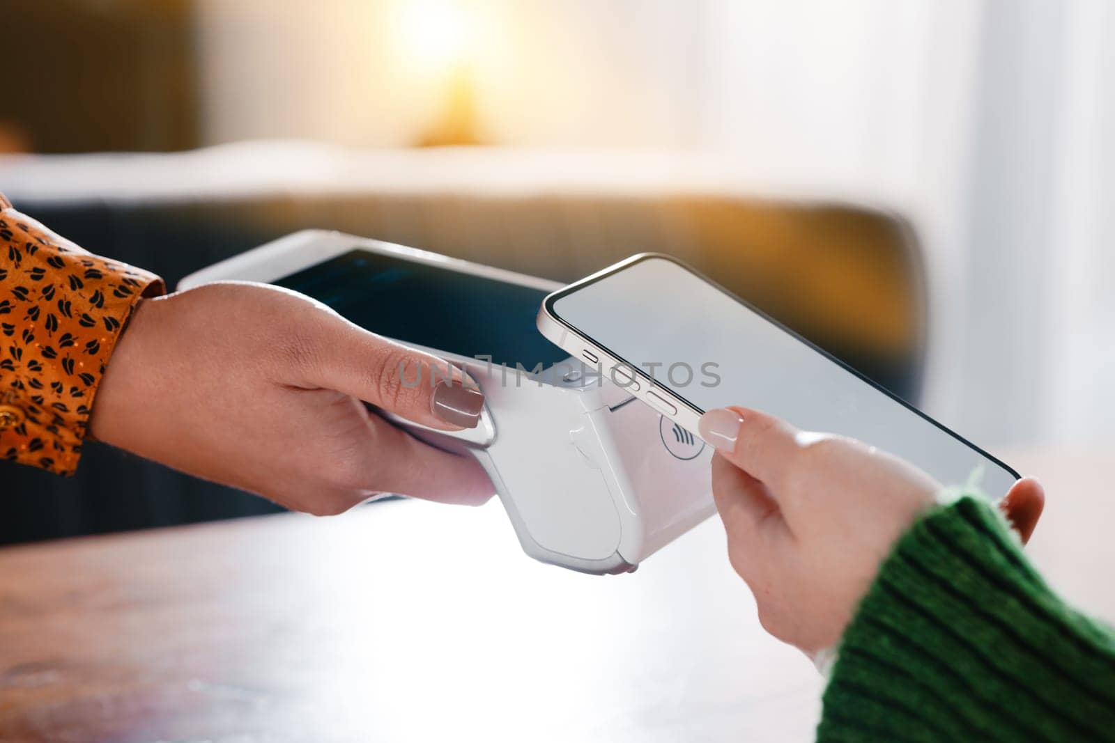 Hands engaged in contactless payment with smartphones and terminals, showcasing contemporary ecommerce technology