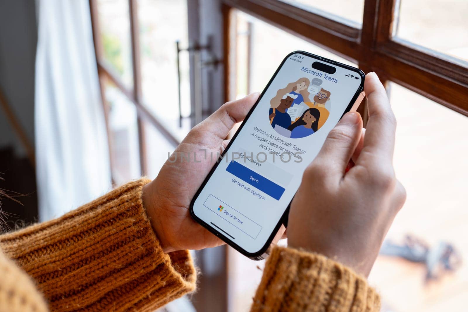 30 April 2023 Chiangmai, Thailand : Woman holding smartphone mobile show Microsoft Teams social platform, group chat platform app.