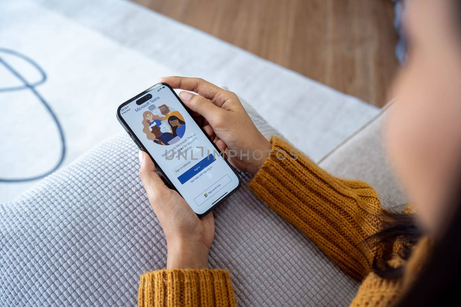 30 April 2023 Chiangmai, Thailand : Woman holding smartphone mobile show Microsoft Teams social platform, group chat platform app.