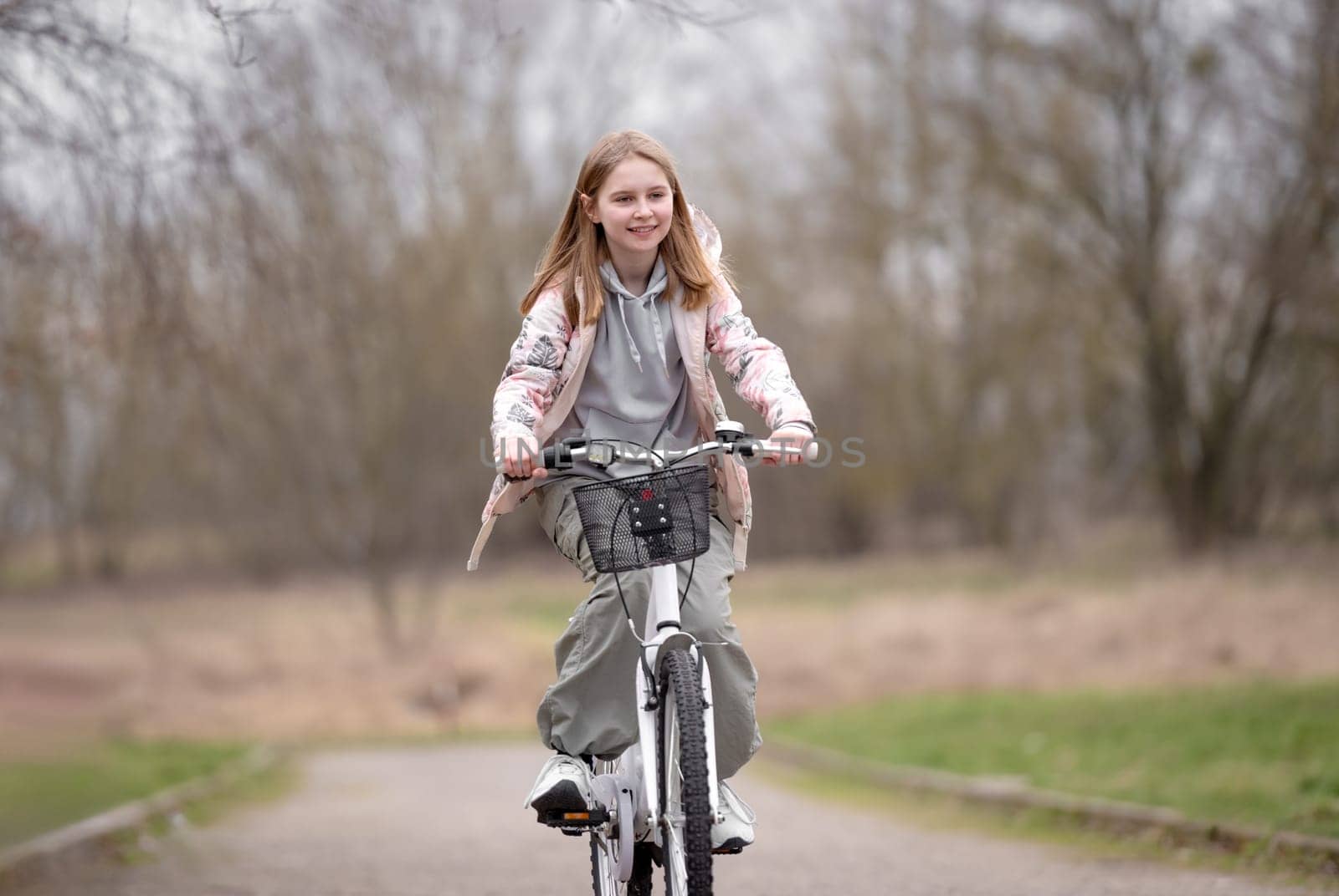 Warm Weather Sees Girl Riding Bicycle Through Spring Park