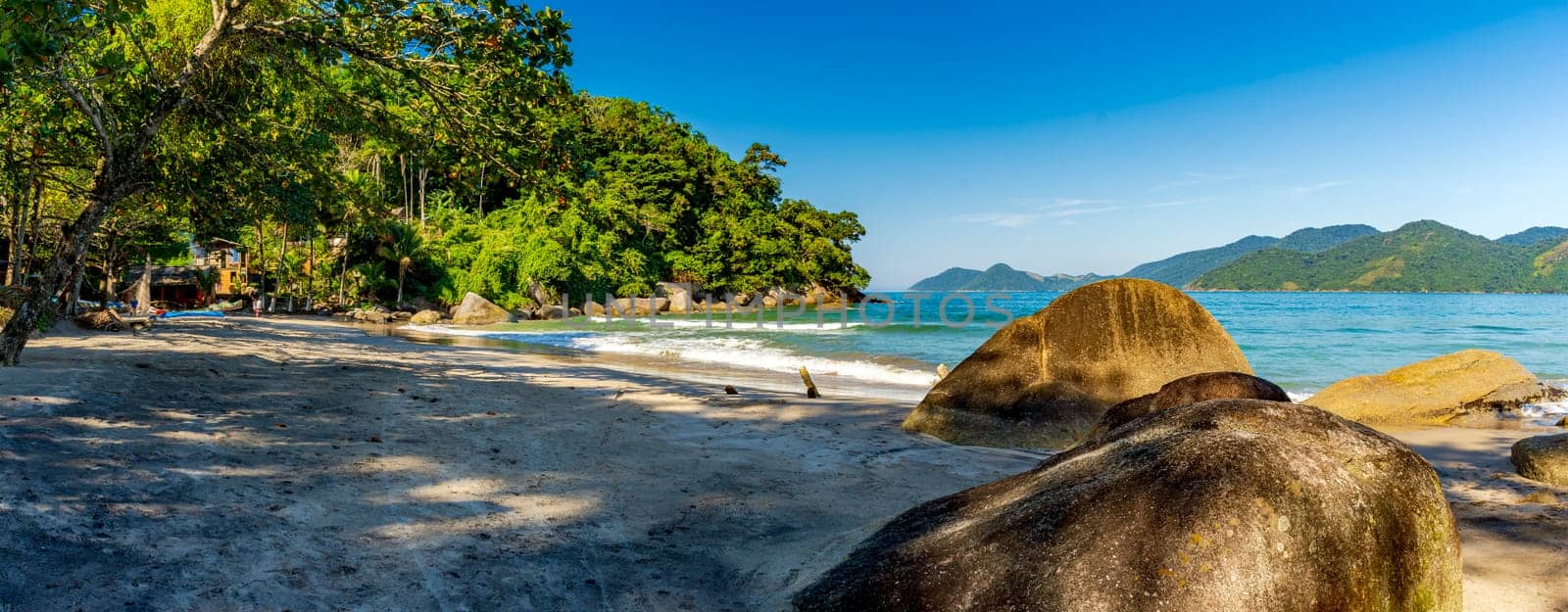 Castelhanos beach surrounded by forest and mountains on the island of Ilhabela in Sao Paulo