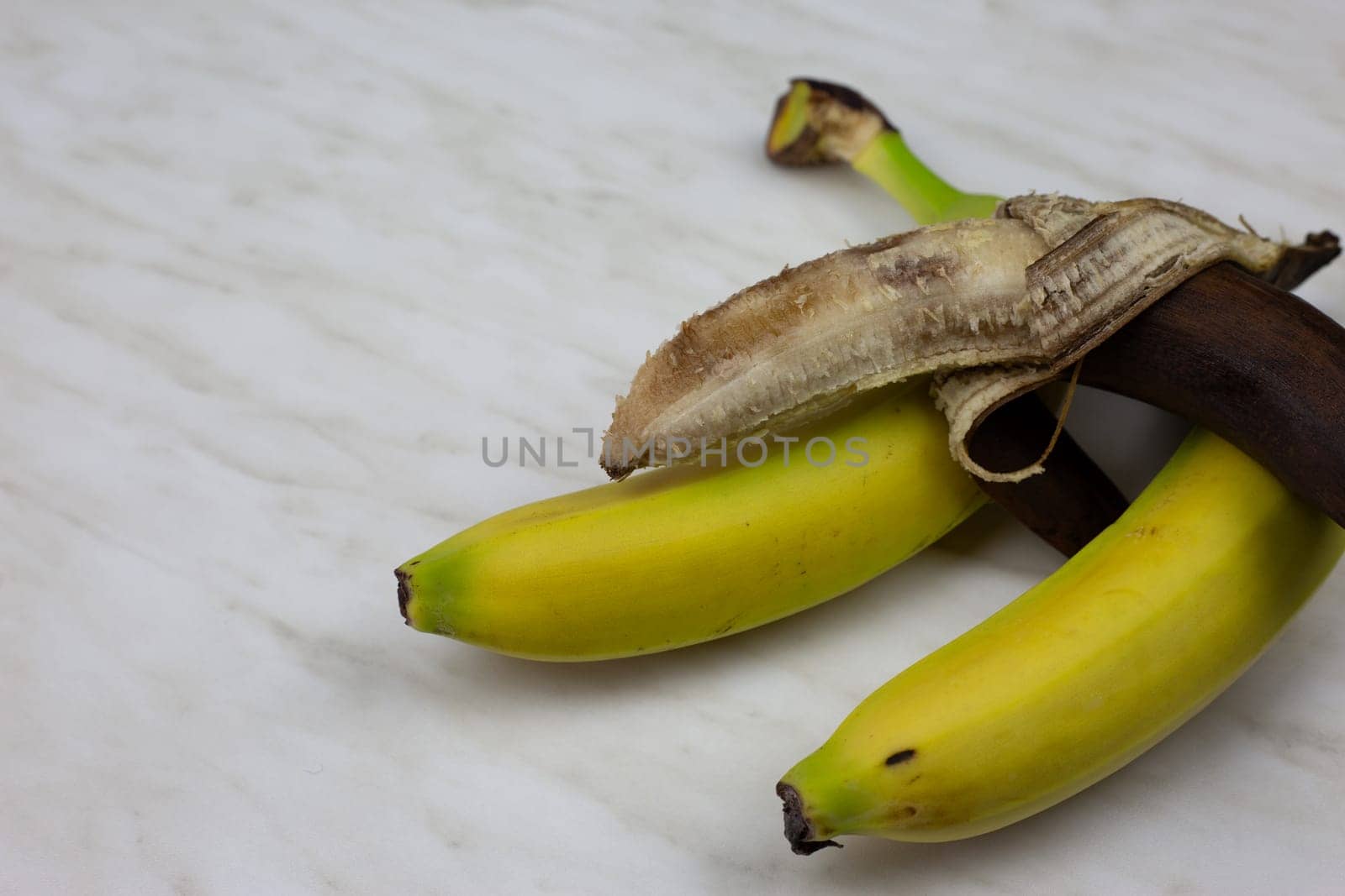 Dirty banana in open peel spoiled banana fruit on table by timurmalazoniia