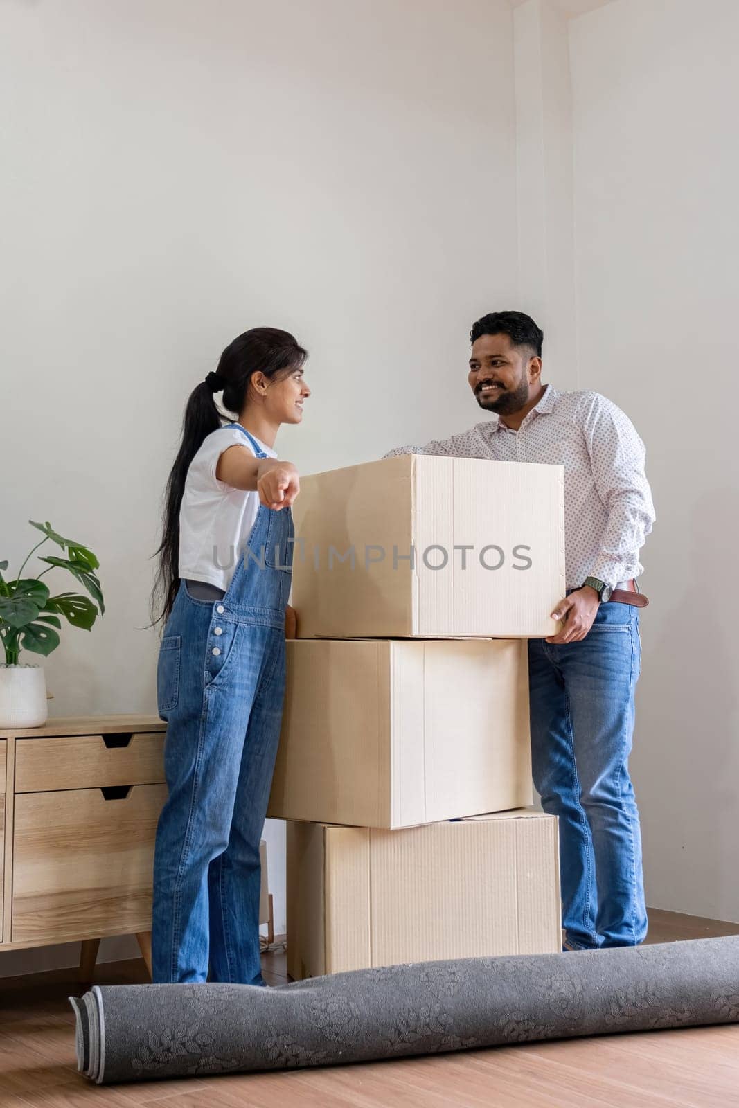 Arab Couple Moving into New Home Together, Carrying Boxes and Unpacking, Happy and Excited, Modern Lifestyle, Relocation, Teamwork, Family Bonding, New Beginnings, Home Interior, Moving Day by wichayada