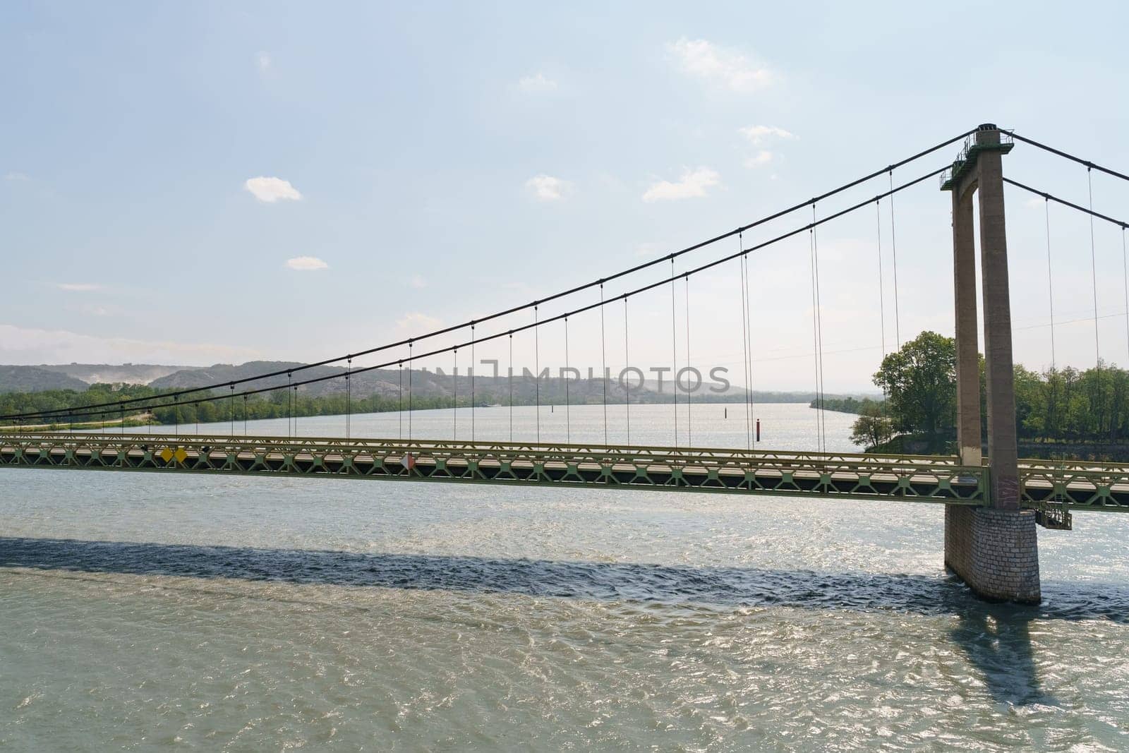 Suspension Bridge Over River With Green Hills In Background by Sd28DimoN_1976