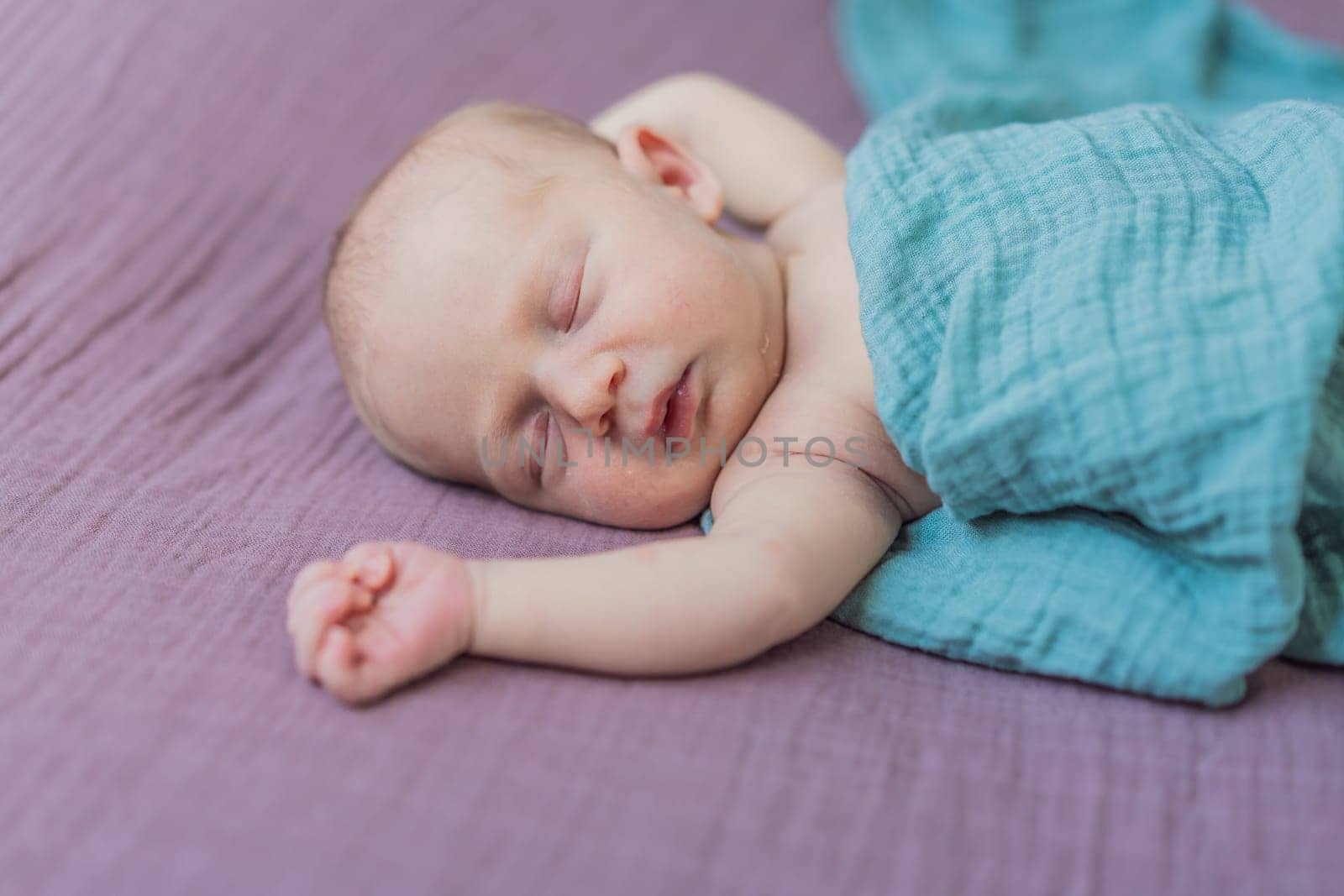 The baby is sleeping peacefully in his cozy nest. Newborn photo session captures the serene innocence and warmth of early moments.
