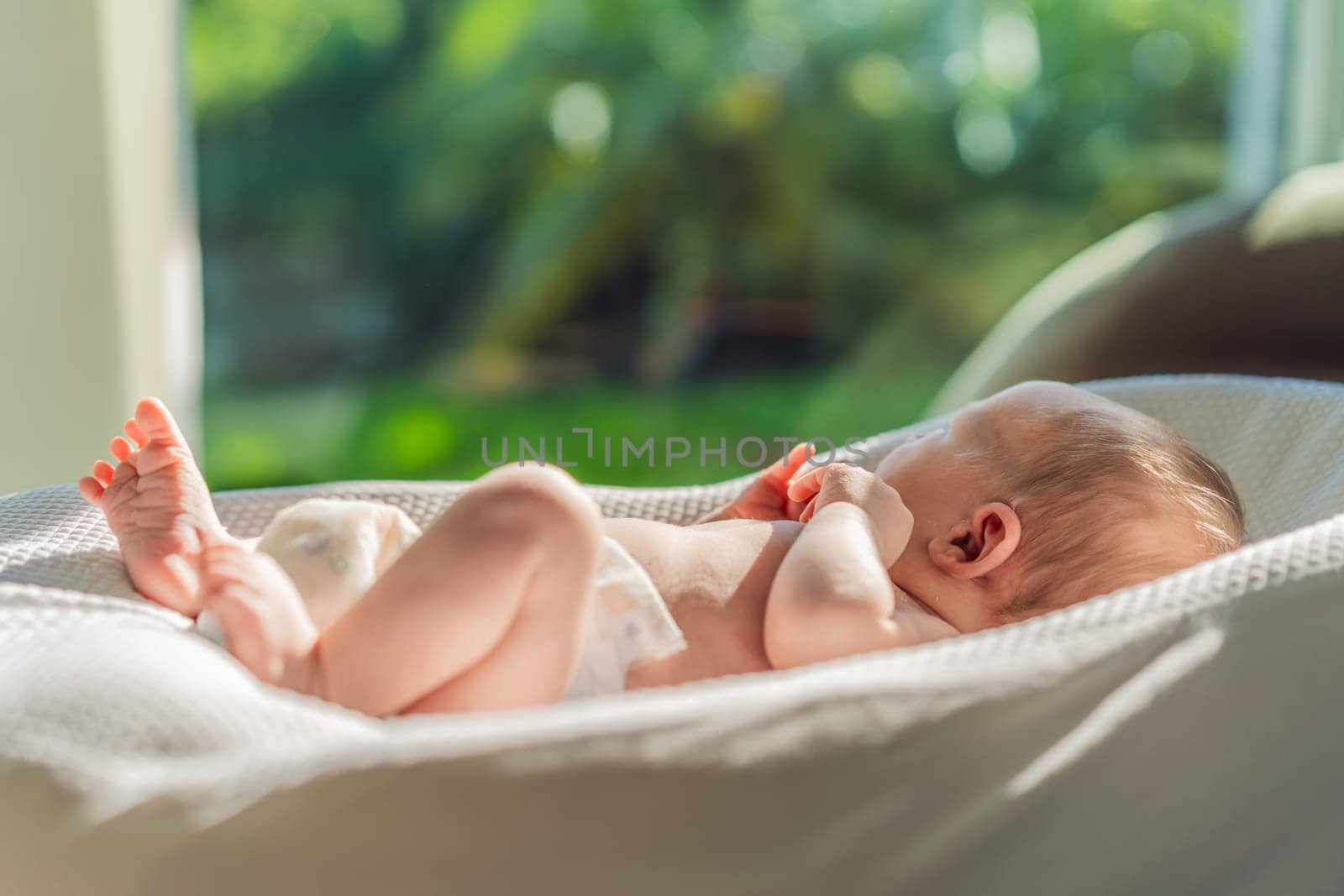 Baby basks in the sun, absorbing vitamin D. This sunny moment highlights the importance of natural light for the baby's health and development, promoting overall well-being and joy.