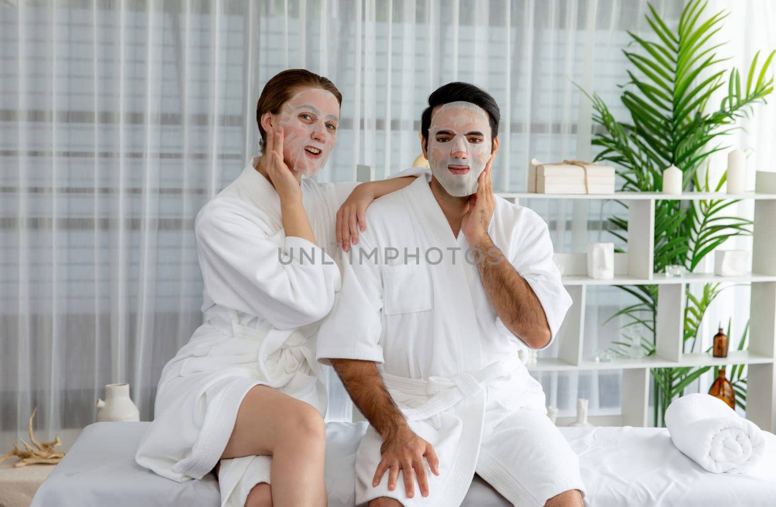 Serene modern daylight ambiance of spa salon, couple customer indulges in rejuvenating with facial skincare mask. Facial skin treatment and beauty cosmetology procedure for face. Quiescent