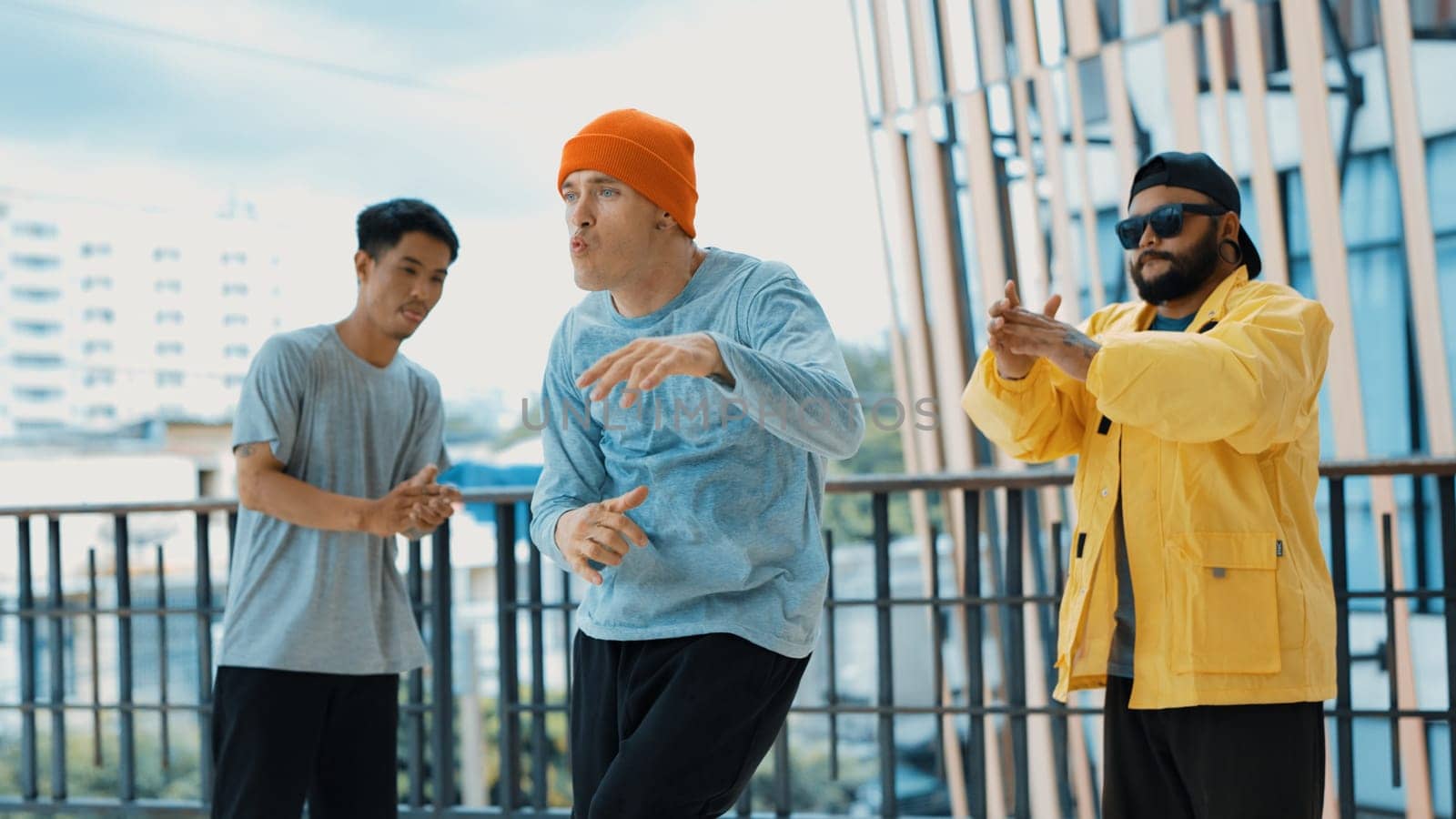 Hip hop team dance break dance while multicultural friend surrounded and clapping hands to cheer or encourage his friend to dance. Active and energetic street dance. Outdoor sport 2024. Endeavor.