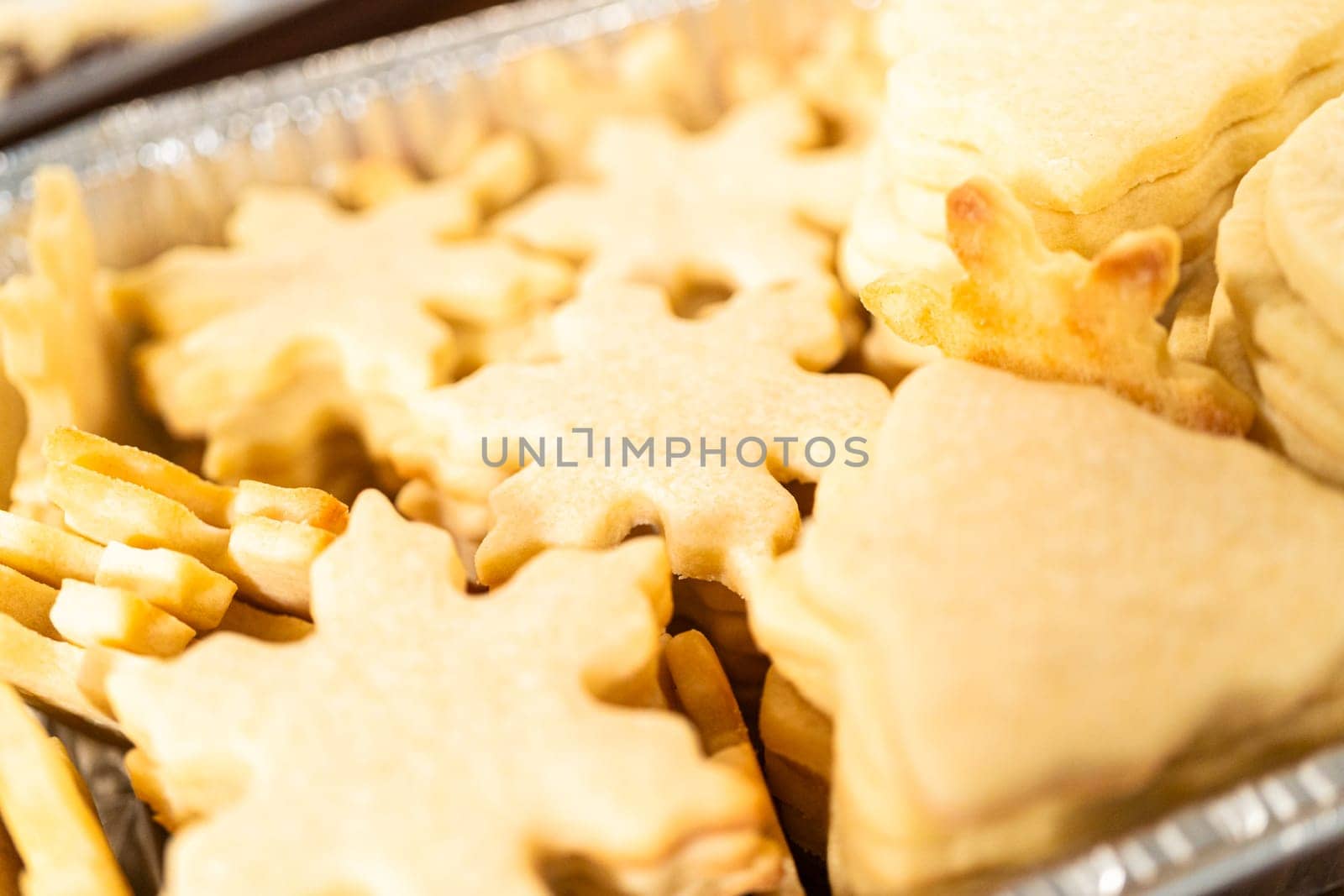 Rustic charm in a pile of undecorated snowflake sugar cookies, ready for festive embellishment as Christmas gifts.