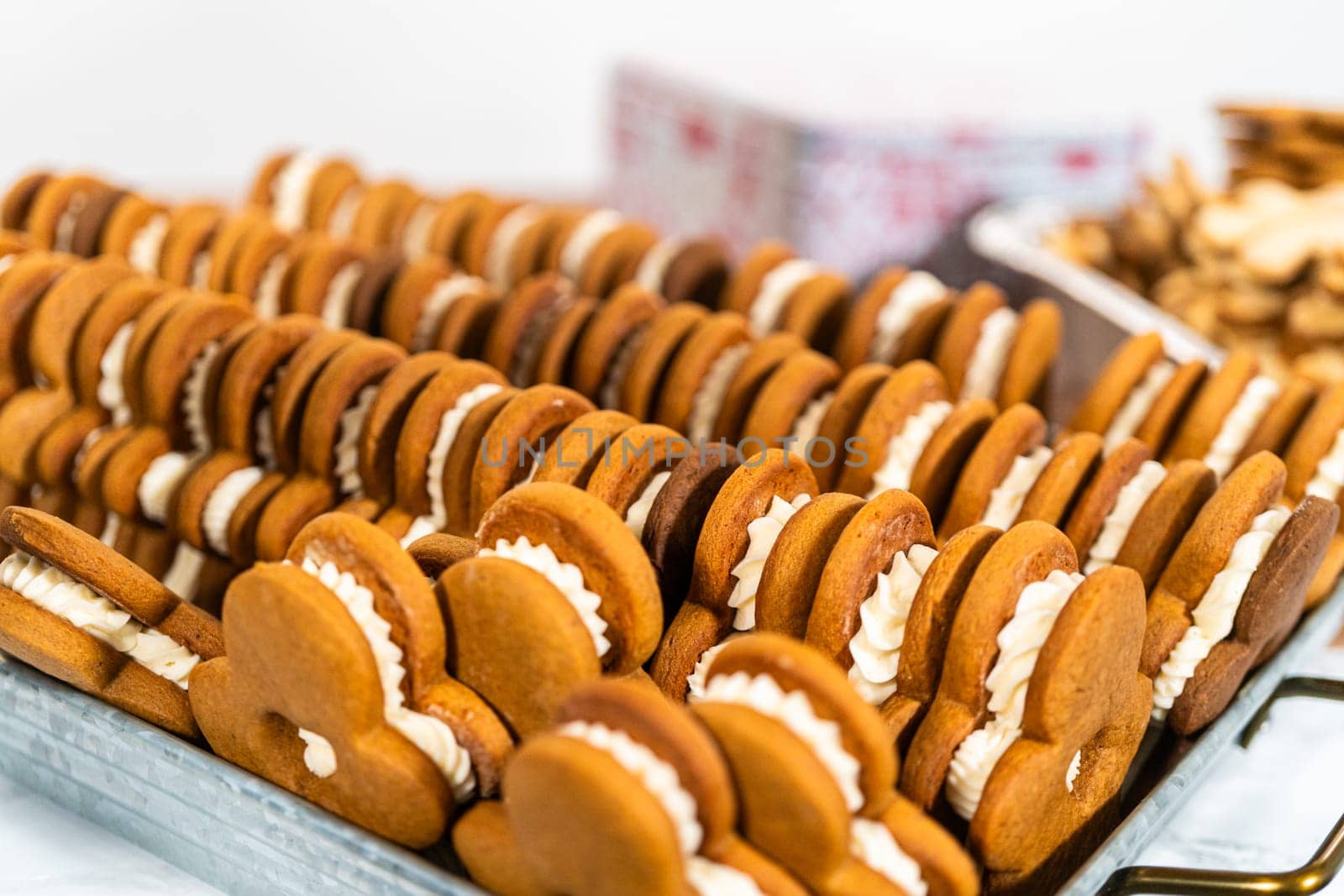 Making Festive Gingerbread Sandwiches on Rustic Wooden Table by arinahabich