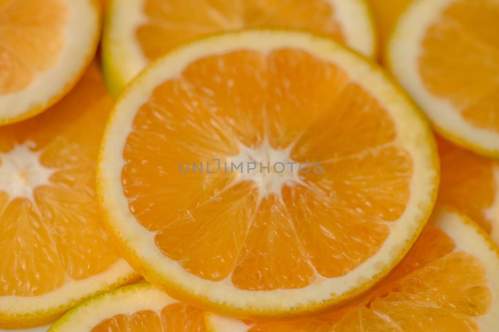 Sliced orange circles, laid on the surface in several layers. Tropical background for design and web 2