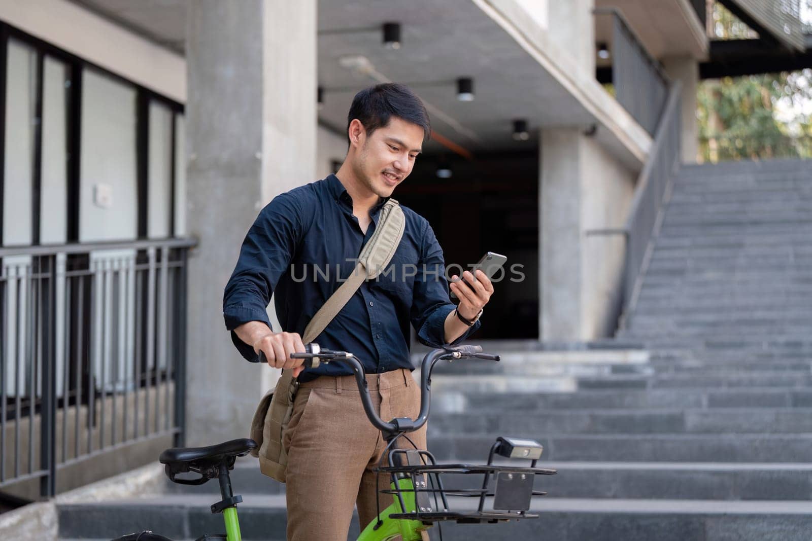 Businessman commuting on a bicycle, using a smartphone, promoting eco-friendly and sustainable transportation in a modern urban environment.