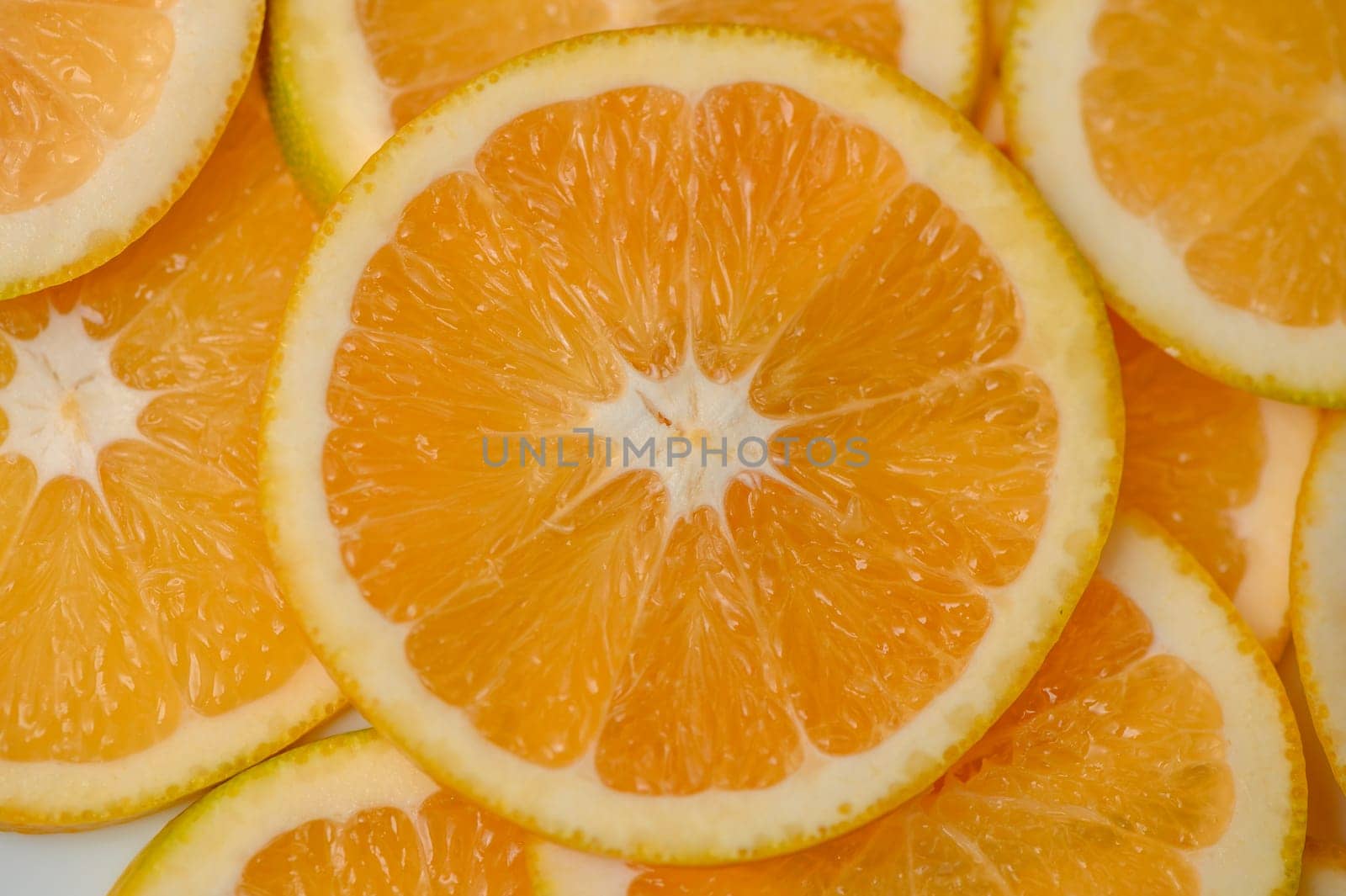 Sliced orange circles, laid on the surface in several layers. Tropical background for design and web by Mixa74