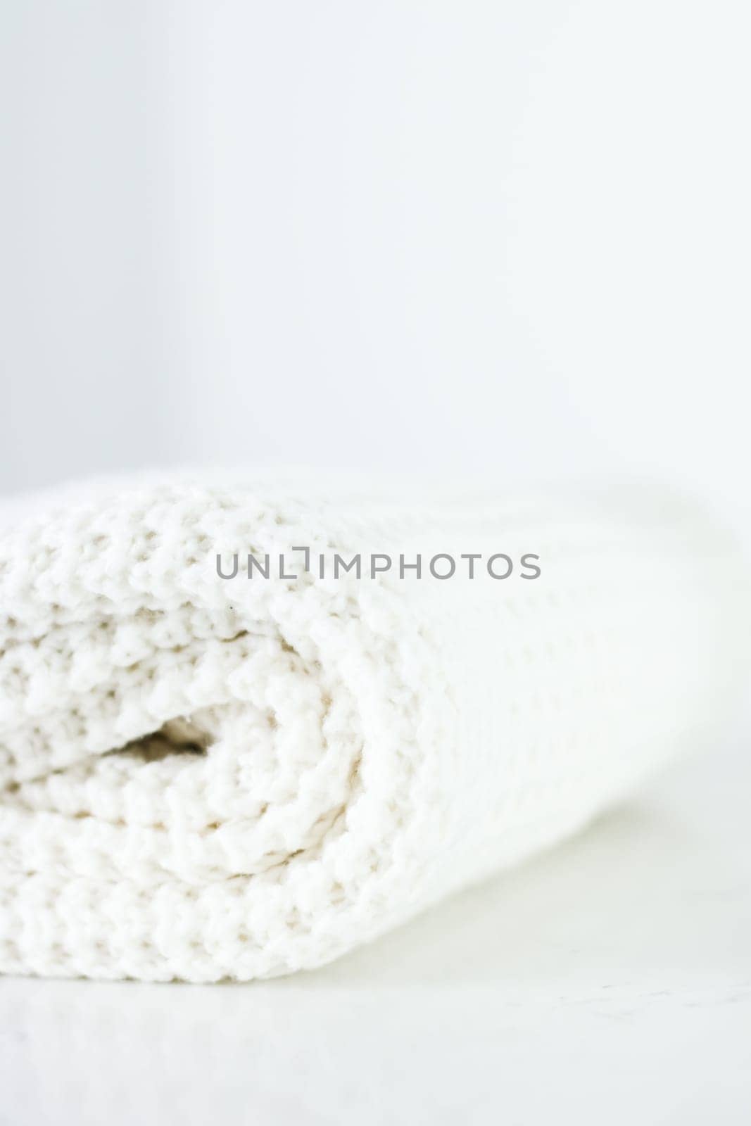 Knitwear, fabric textures and handmade items concept - Warm knitted clothes, soft and white