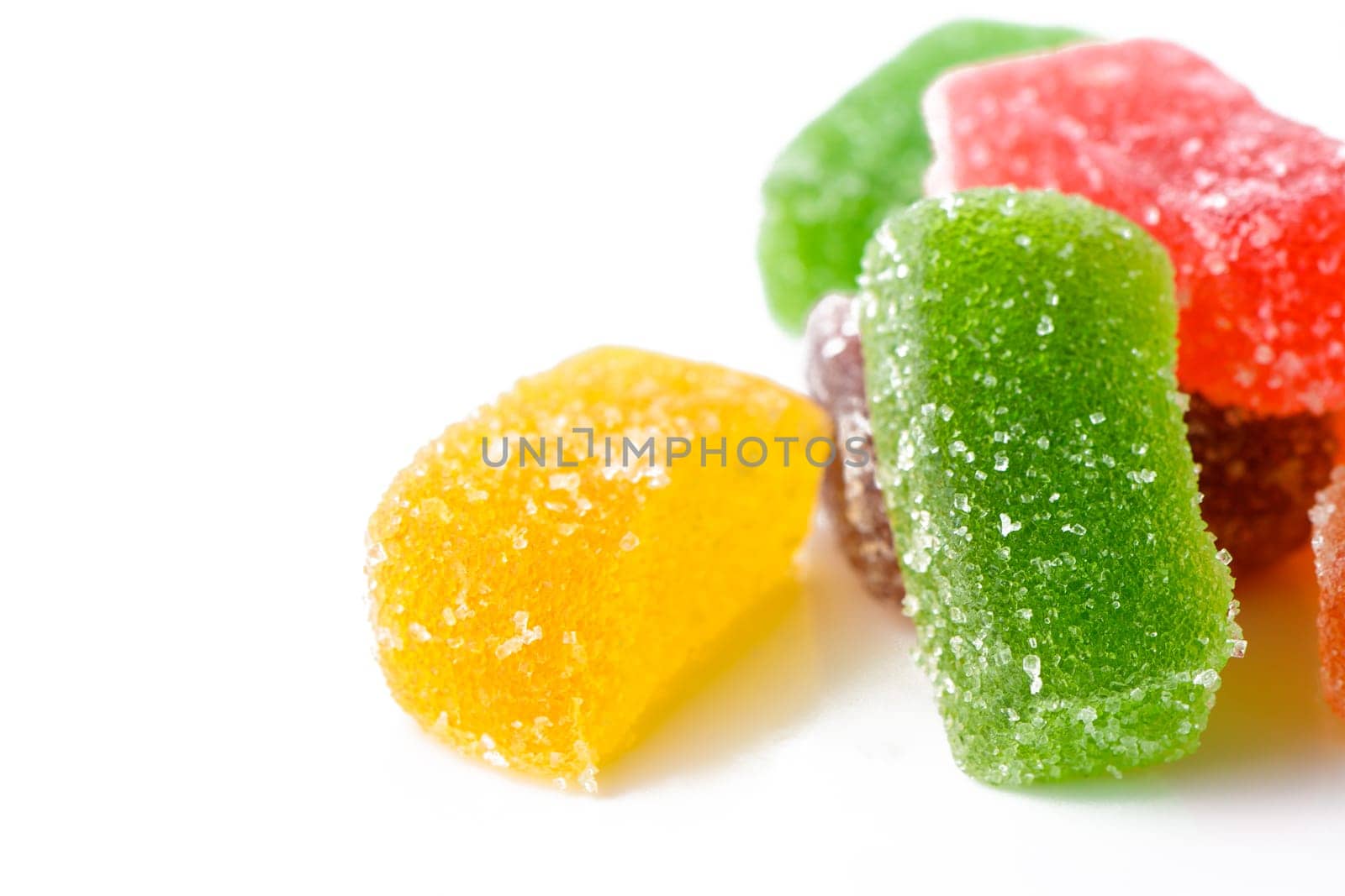 Multi-layered multicolored jelly marmalade of square shape. White background. Close-up by Mixa74
