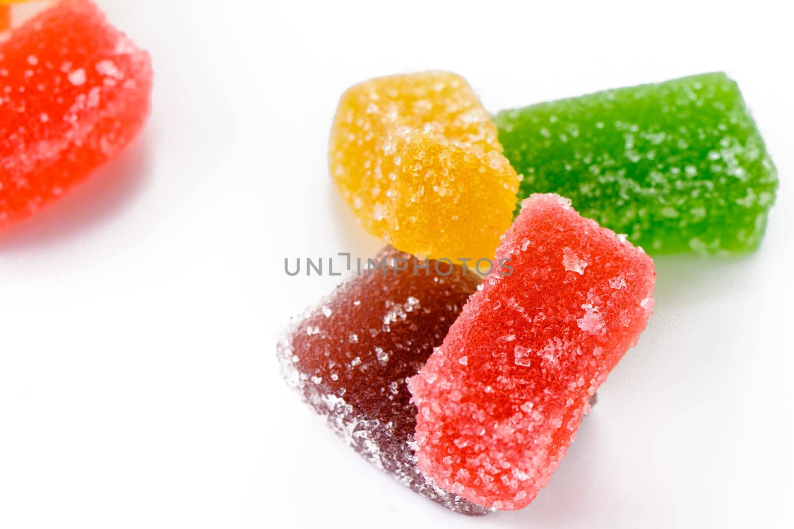 Sweet delicious multi-colored marmalade or jelly candies assorted in sugar sprinkles with fruit and berry flavor on a white background. 2