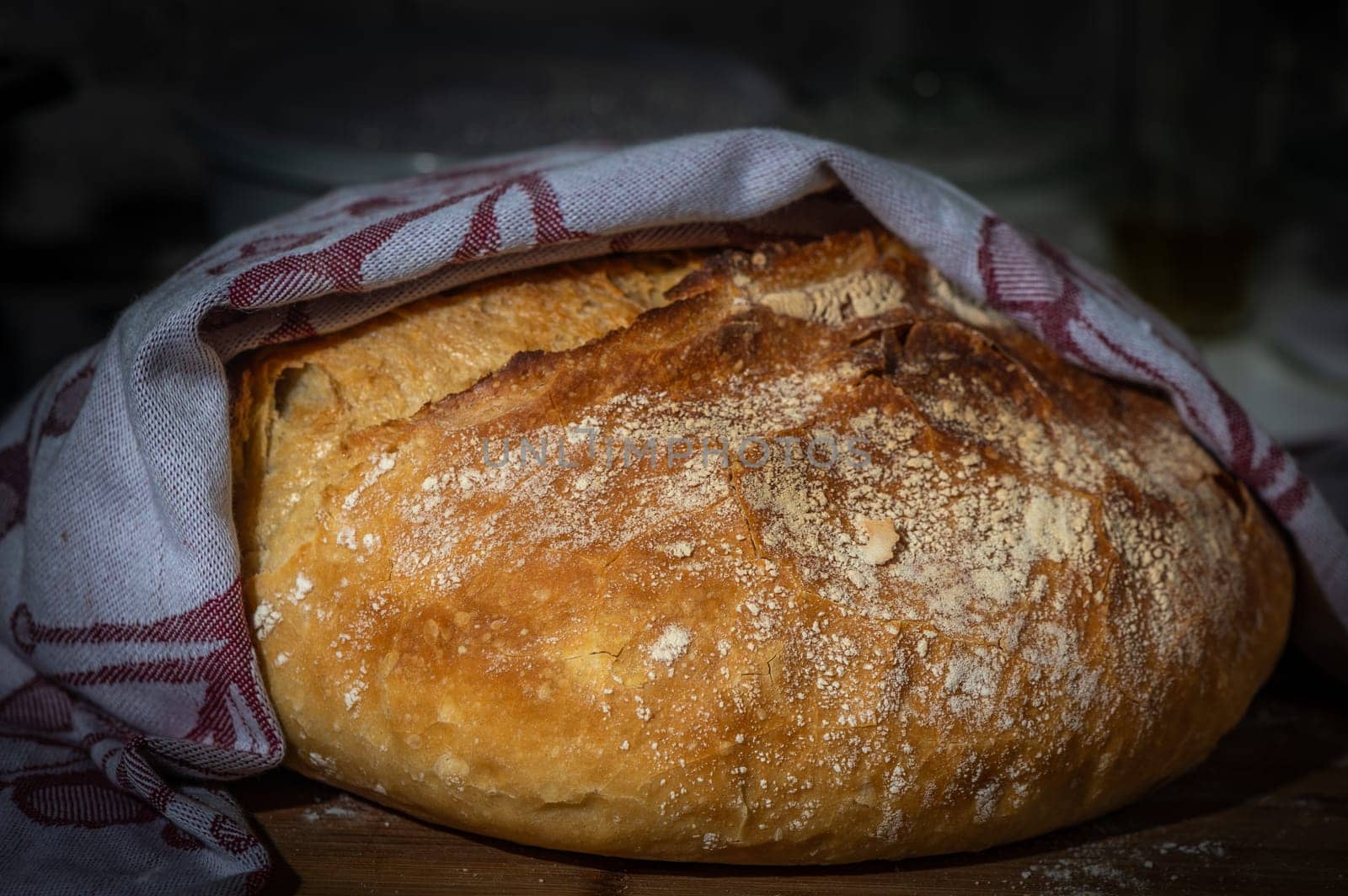 Freshly baked bread on rustic wooden background.