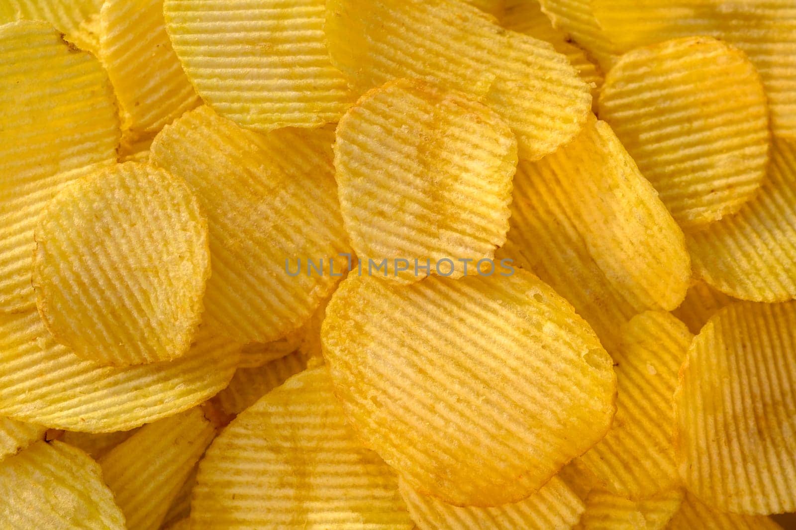 crispy potato chips snack texture background top view by Mixa74