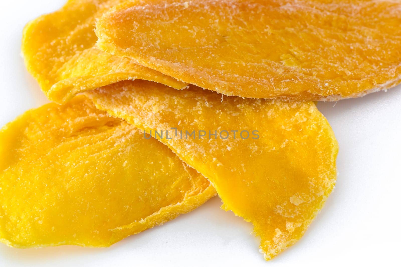 Pile of dried mango slices cut out on transparent background