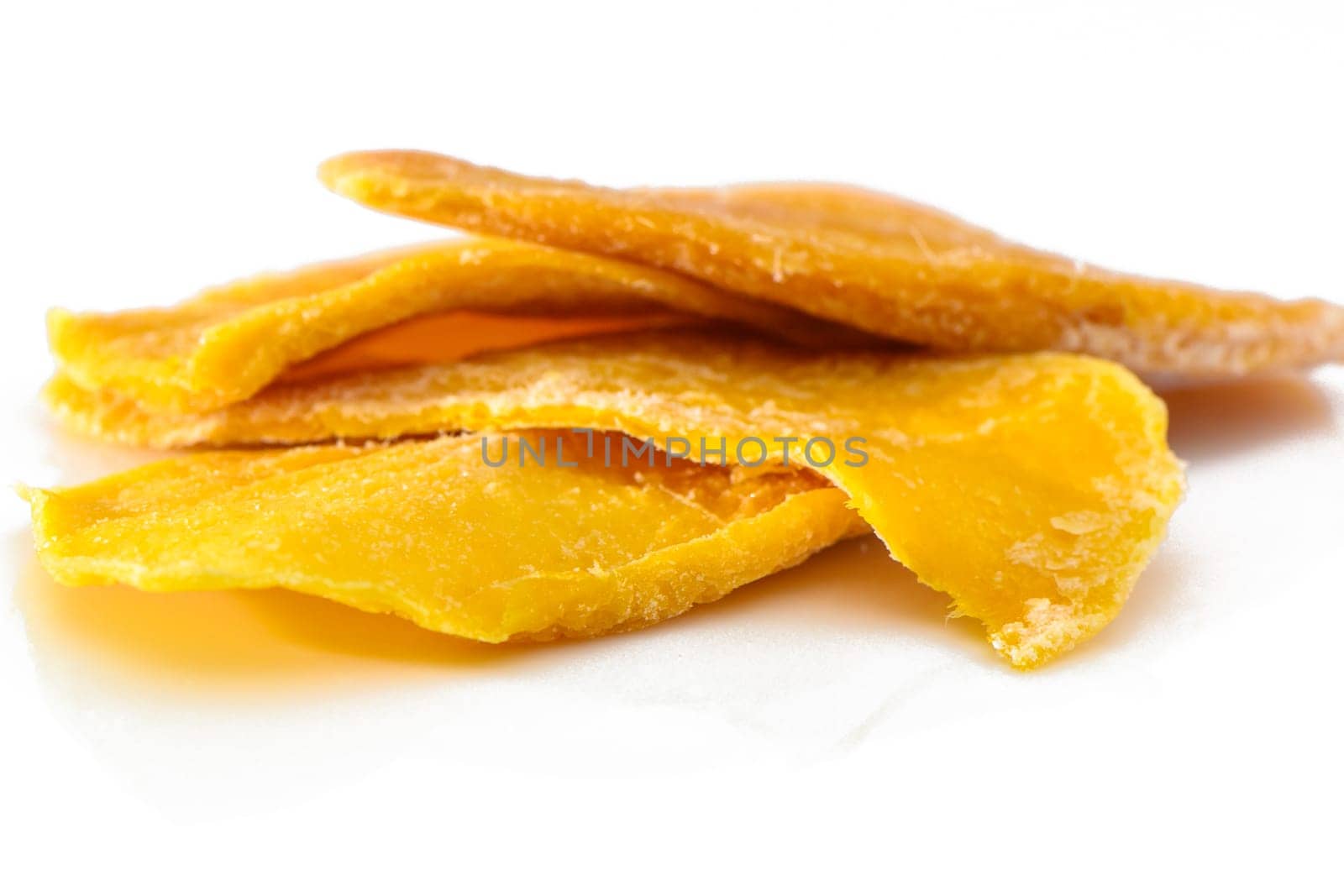 Dried mango slices close-up on a white. Top view 1 by Mixa74