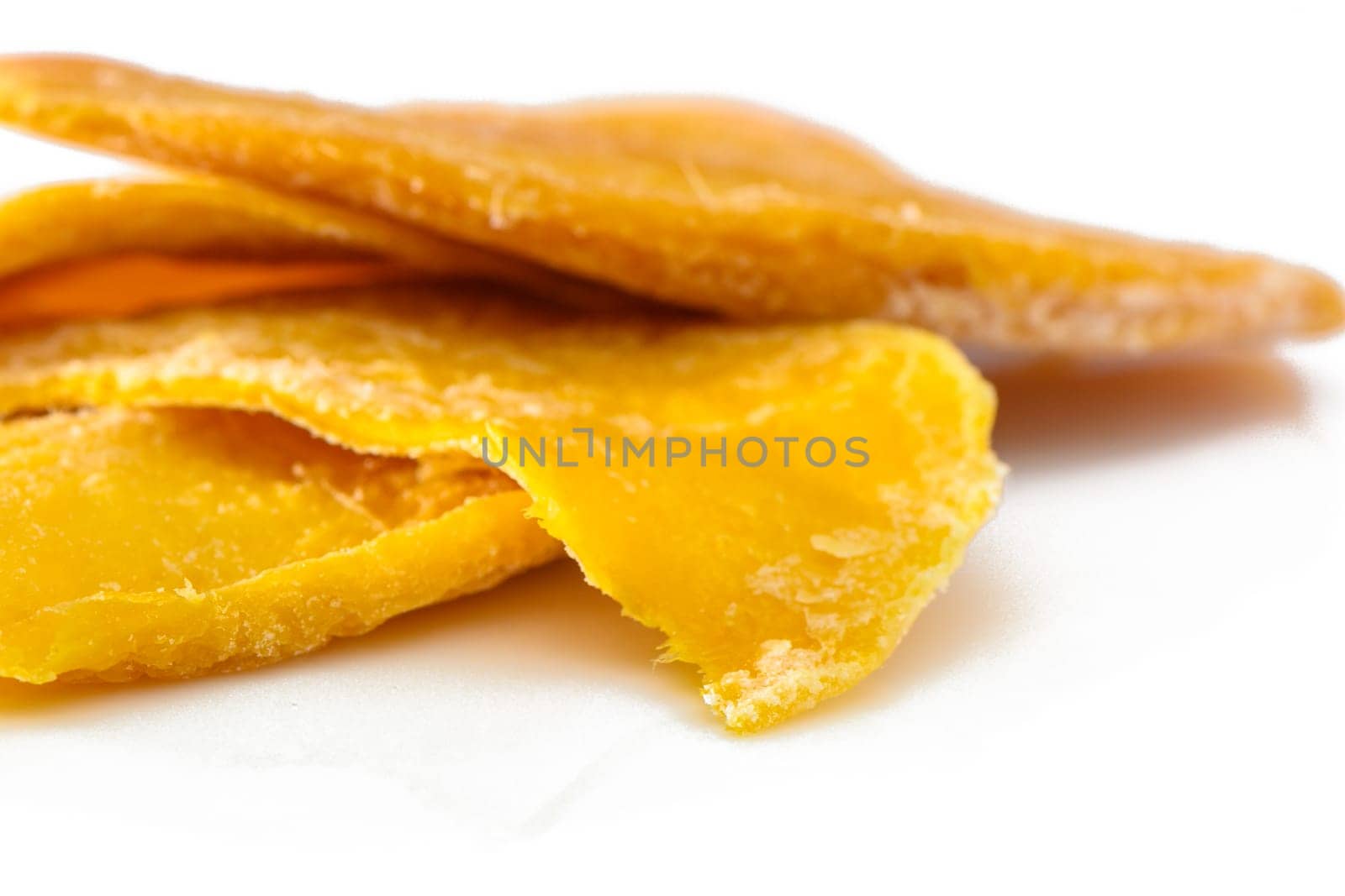 Dried mango slices close-up on a white. Top view 2