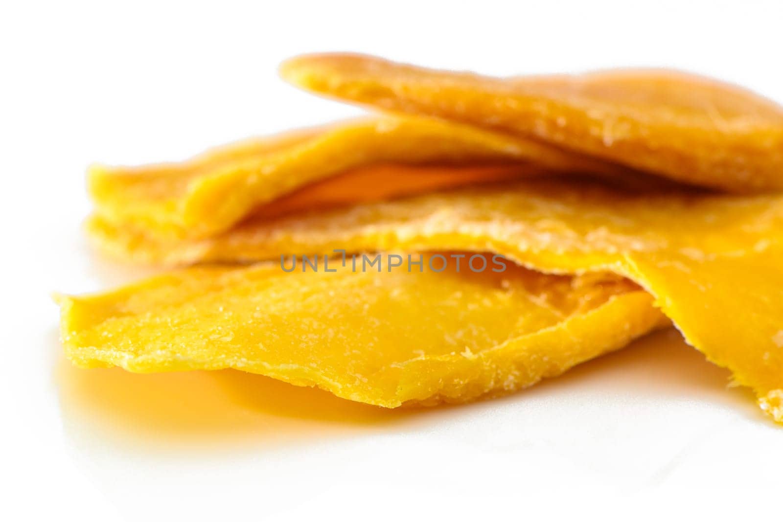 colorful pieces of dried mango fruit on a white background 1