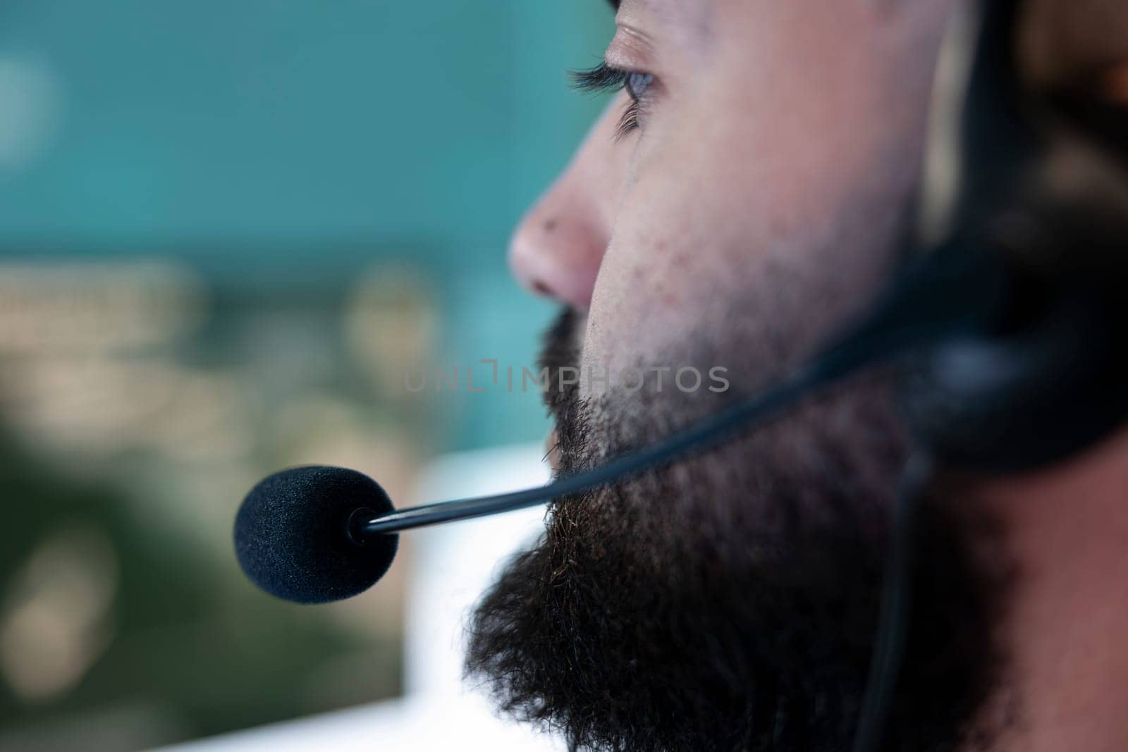 Professional army IT engineer reviews satellite imagery from CCTV radar system, using federal reconnaissance footage. Soldier with headset monitoring ongoing defense operation. Close up.